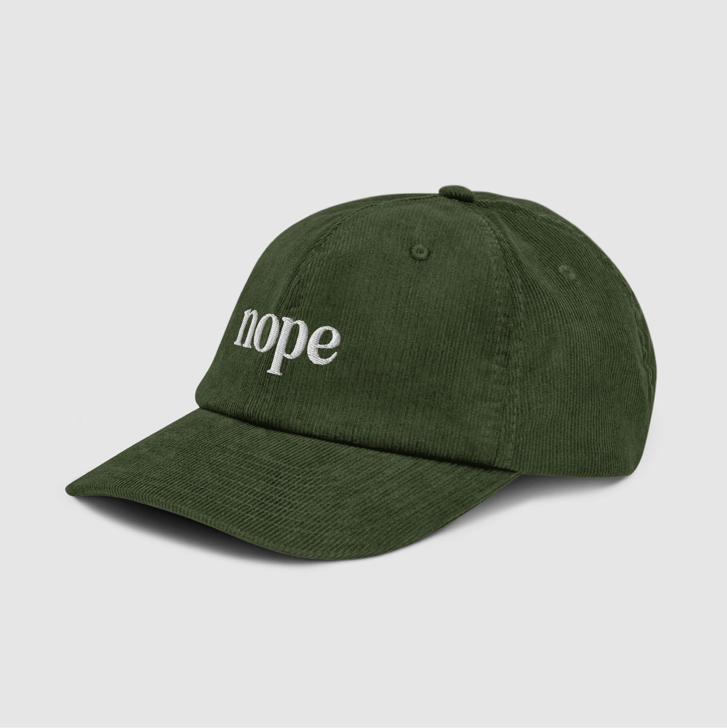 Angled front shot of olive green Nope Dad Cap showing texture and embroidery