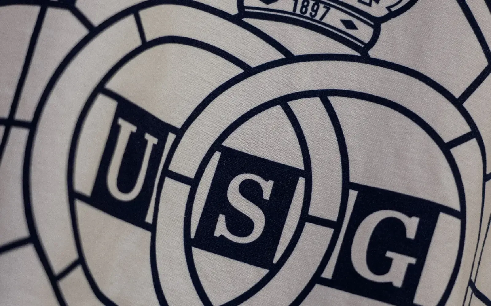 Close-up of a bold football-inspired sportswear graphic designed by Mr. Nope, blending illustration and typography.