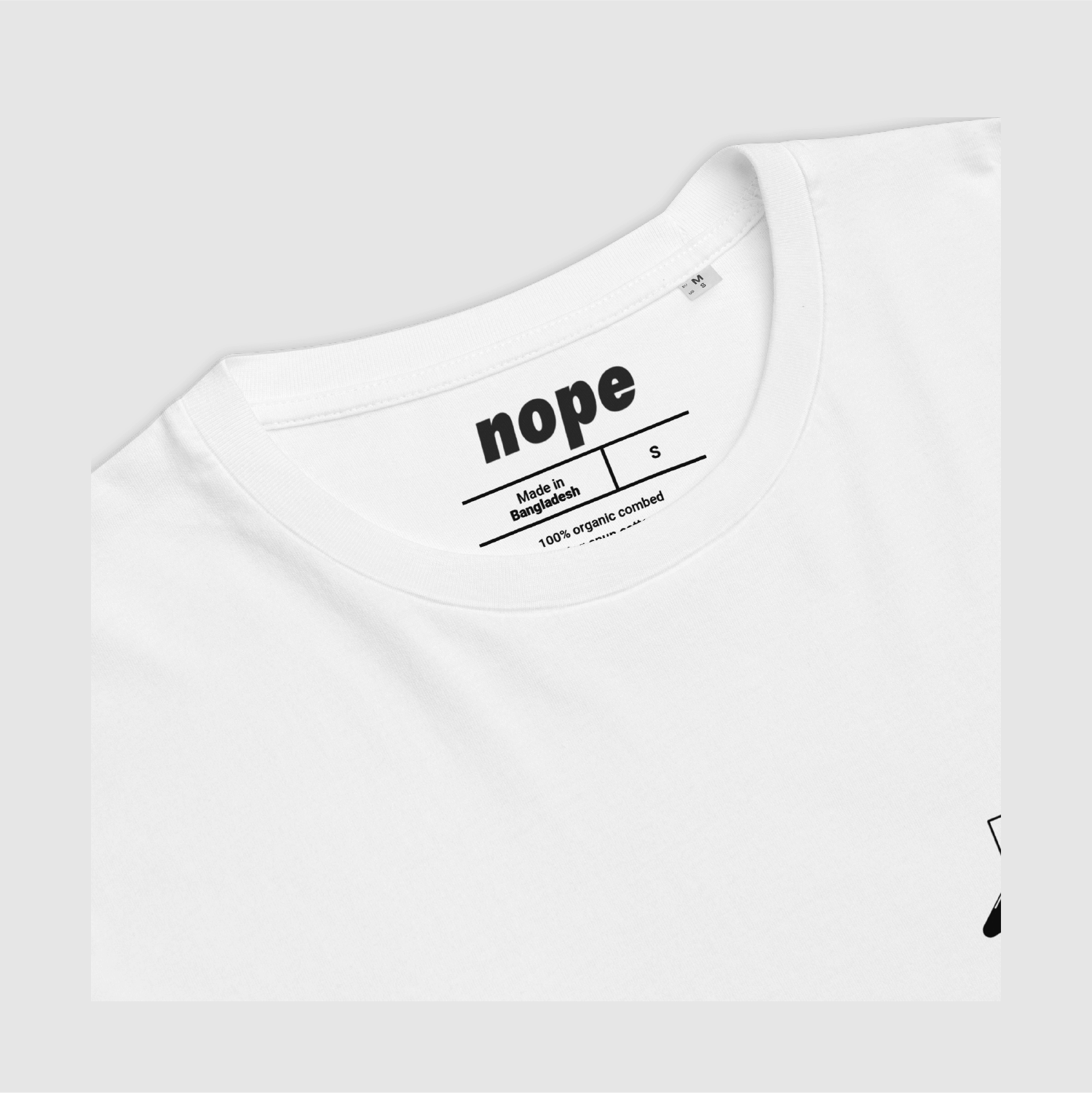 Nope MLLW Tee Detail White: Inner neckline of t-shirt showing Nope branding and 100% organic cotton label print