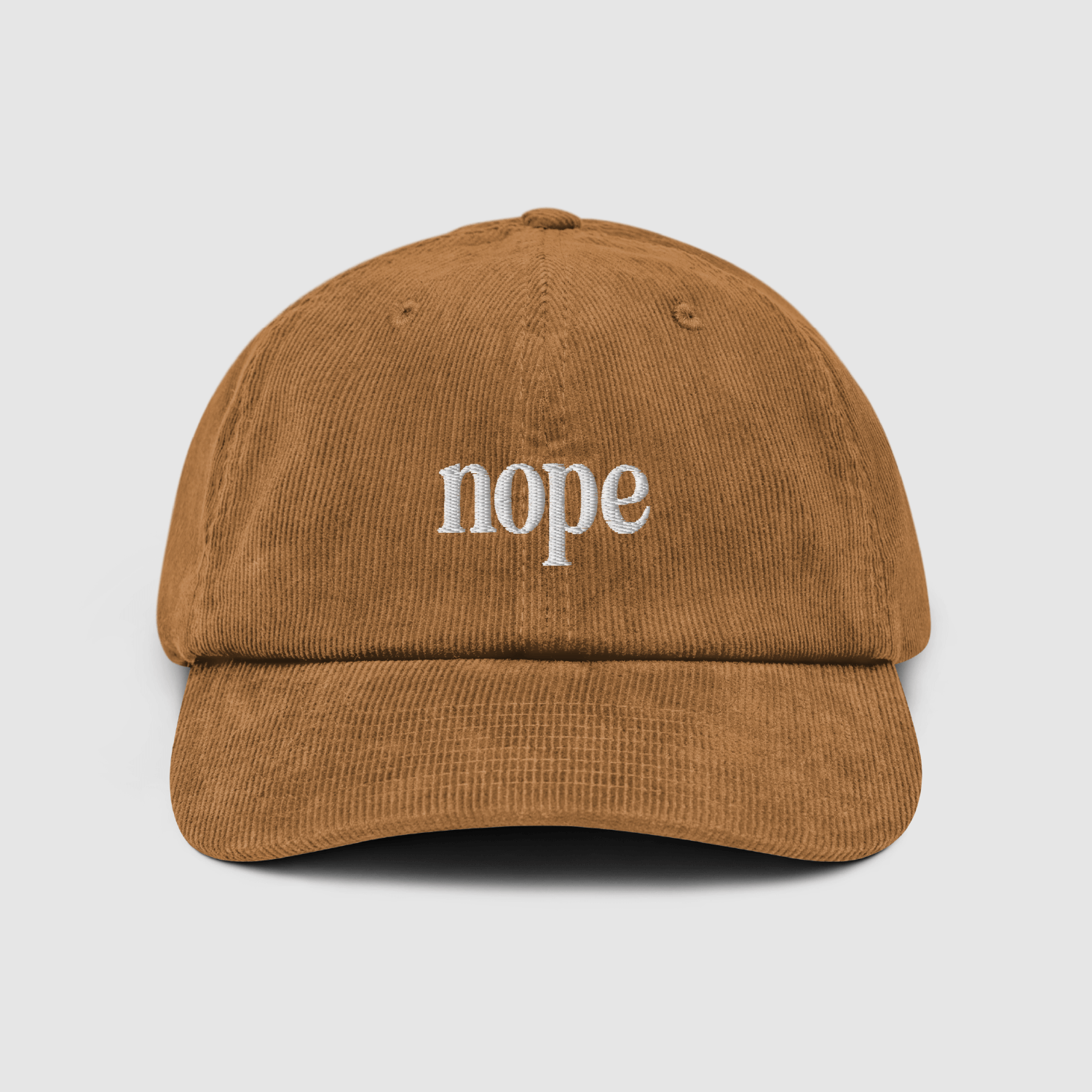 Front view of the Nope Corduroy Dad Cap in camel with white embroidered "nope" logo