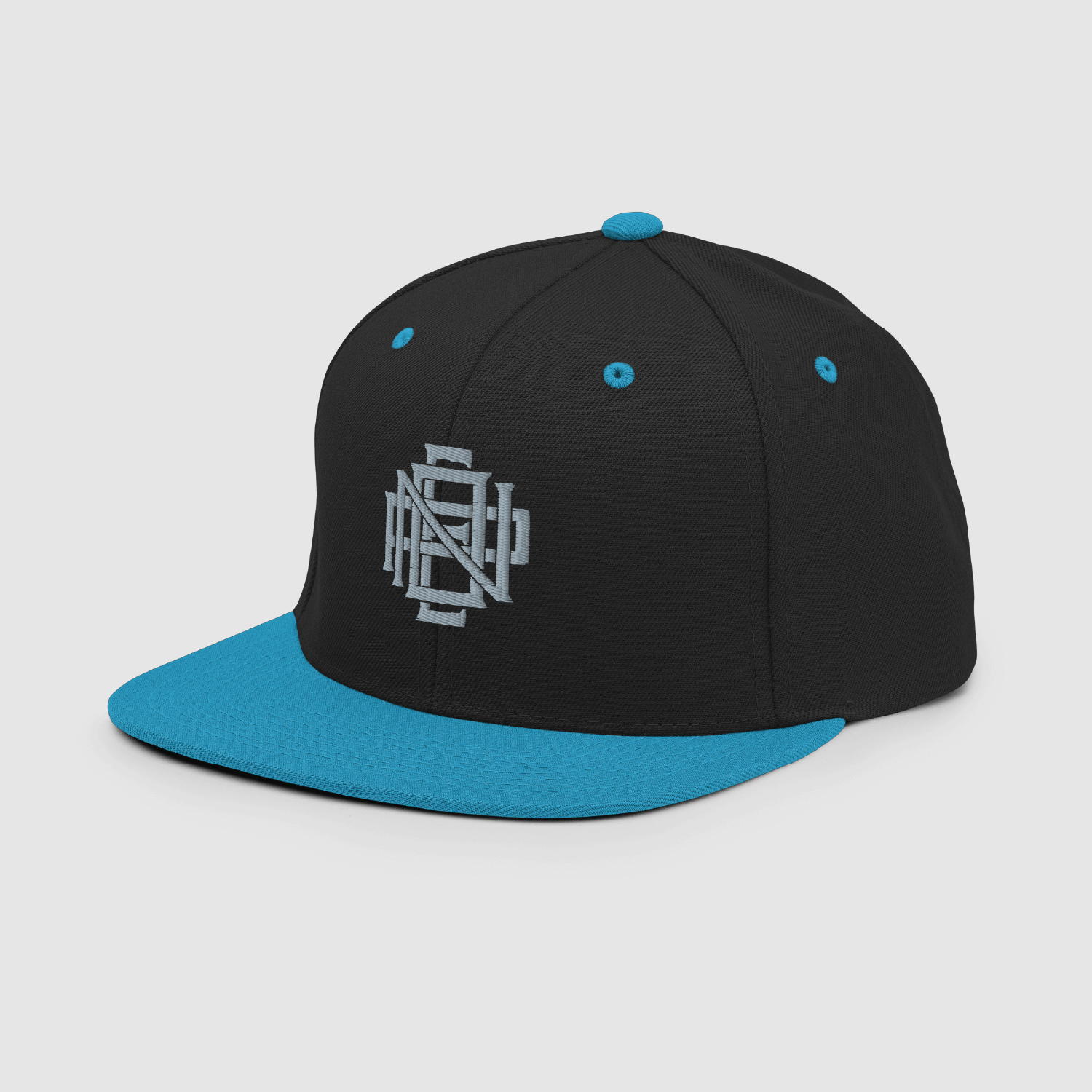 Side angle of black snapback cap with cyan brim and monogram logo