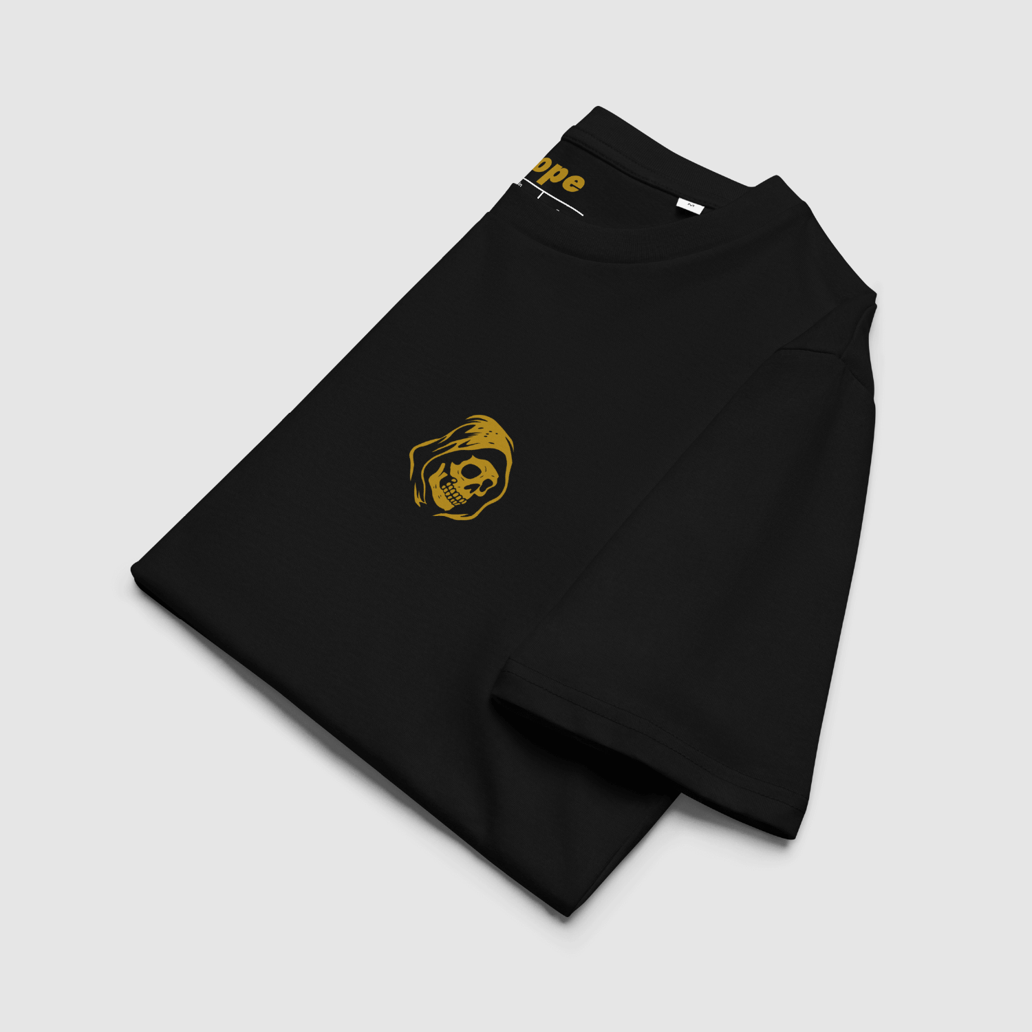 Folded black Zero Fuchs T-Shirt showing left chest skull monk emblem in ochre print with custom neck branding by Mr. Nope.