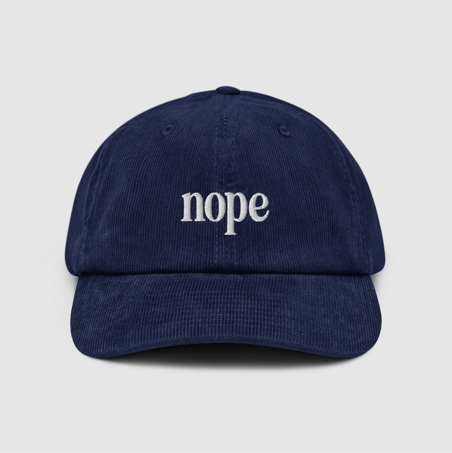 Front view of the Nope Corduroy Dad Cap in Oxford Navy with white embroidery