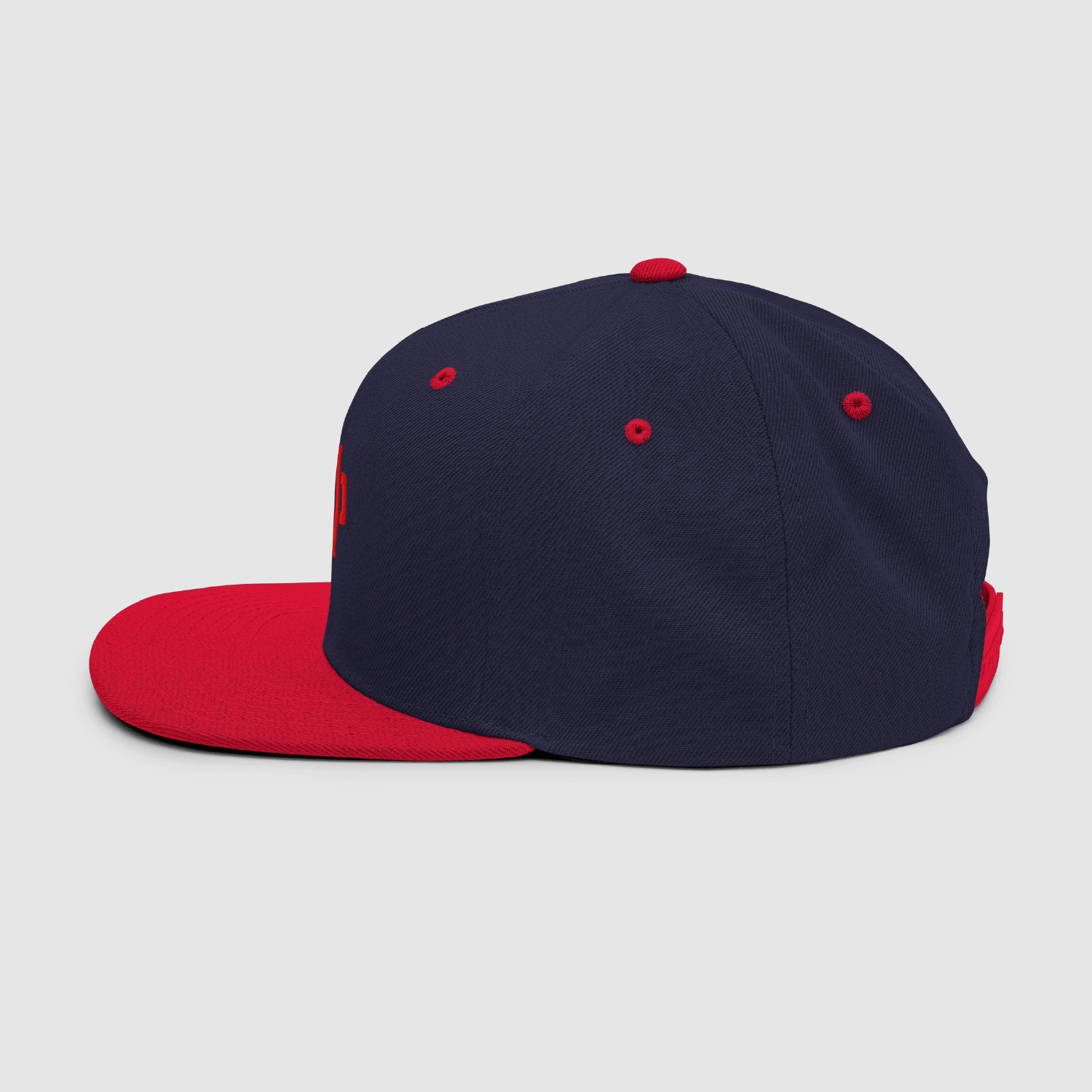 Profile view of navy and red streetwear snapback hat