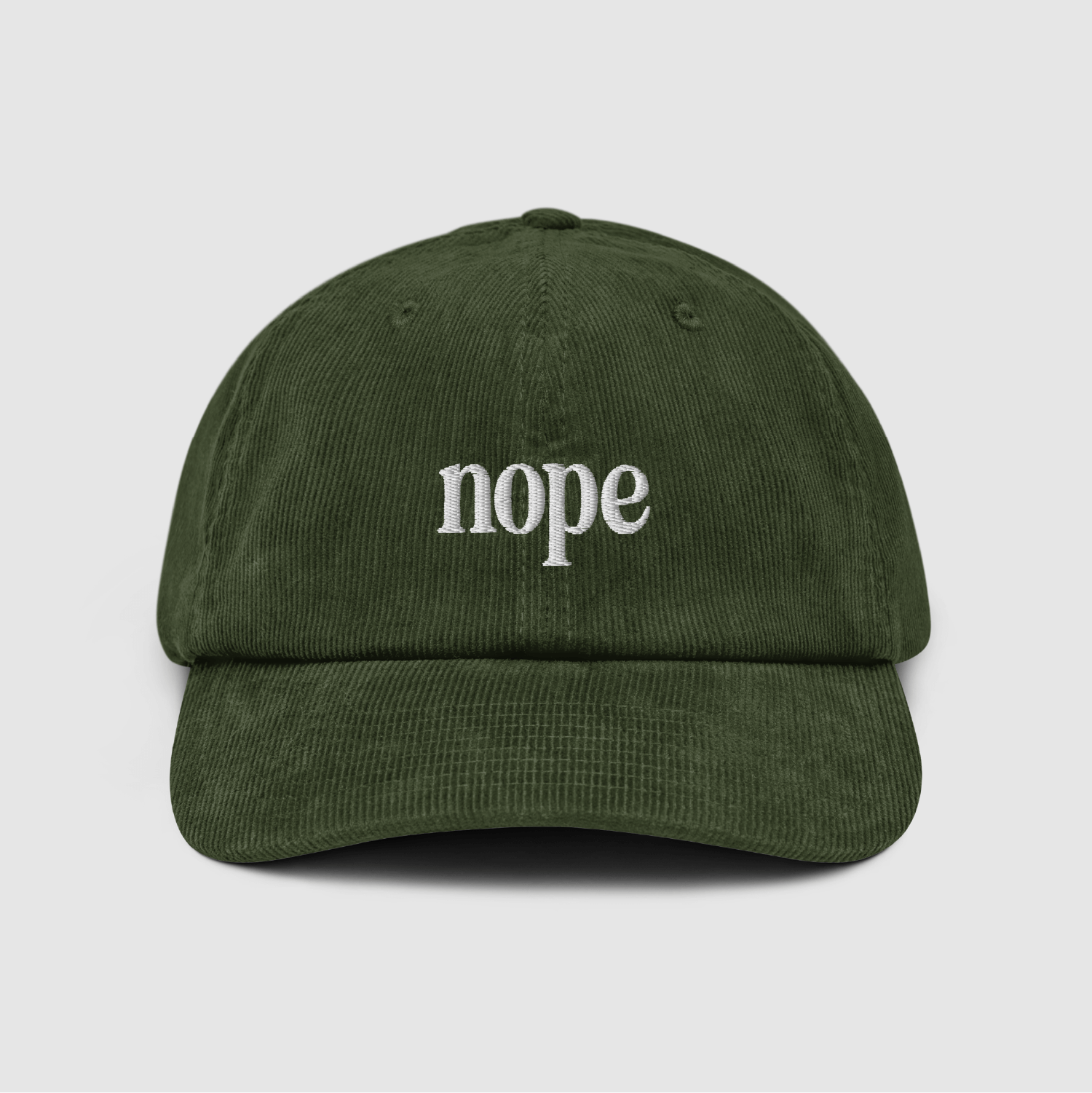 Front view of the Nope Corduroy Dad Cap in olive with white embroidered "nope" text