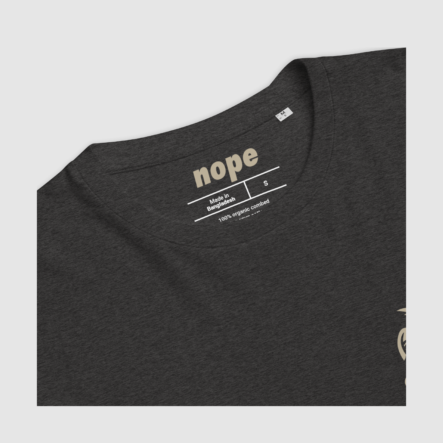 Close-up of Zero Fuchs T-Shirt neckline on dark heather grey tee with custom cream "nope" brand label and sizing.
