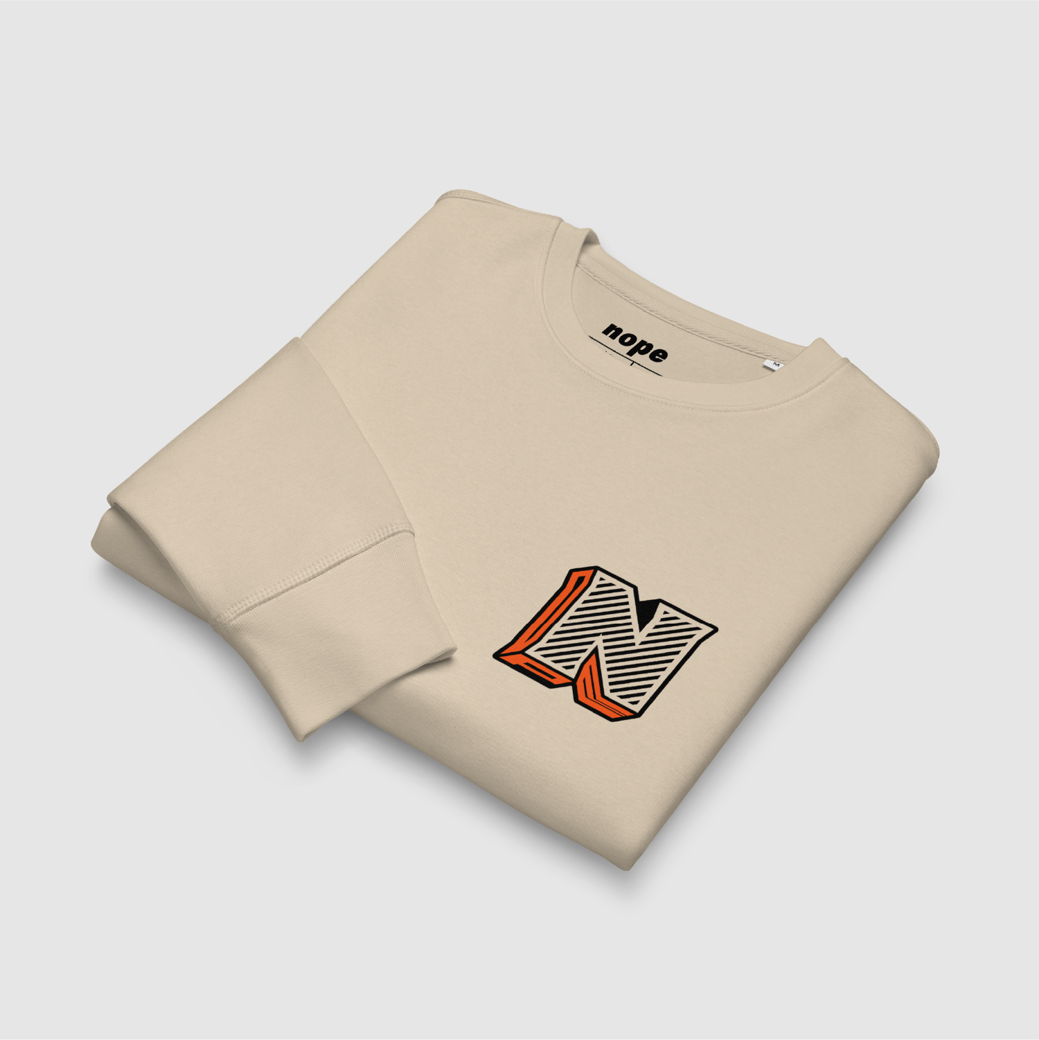Folded Desert Dust sweatshirt with bold orange/black 3D graphic