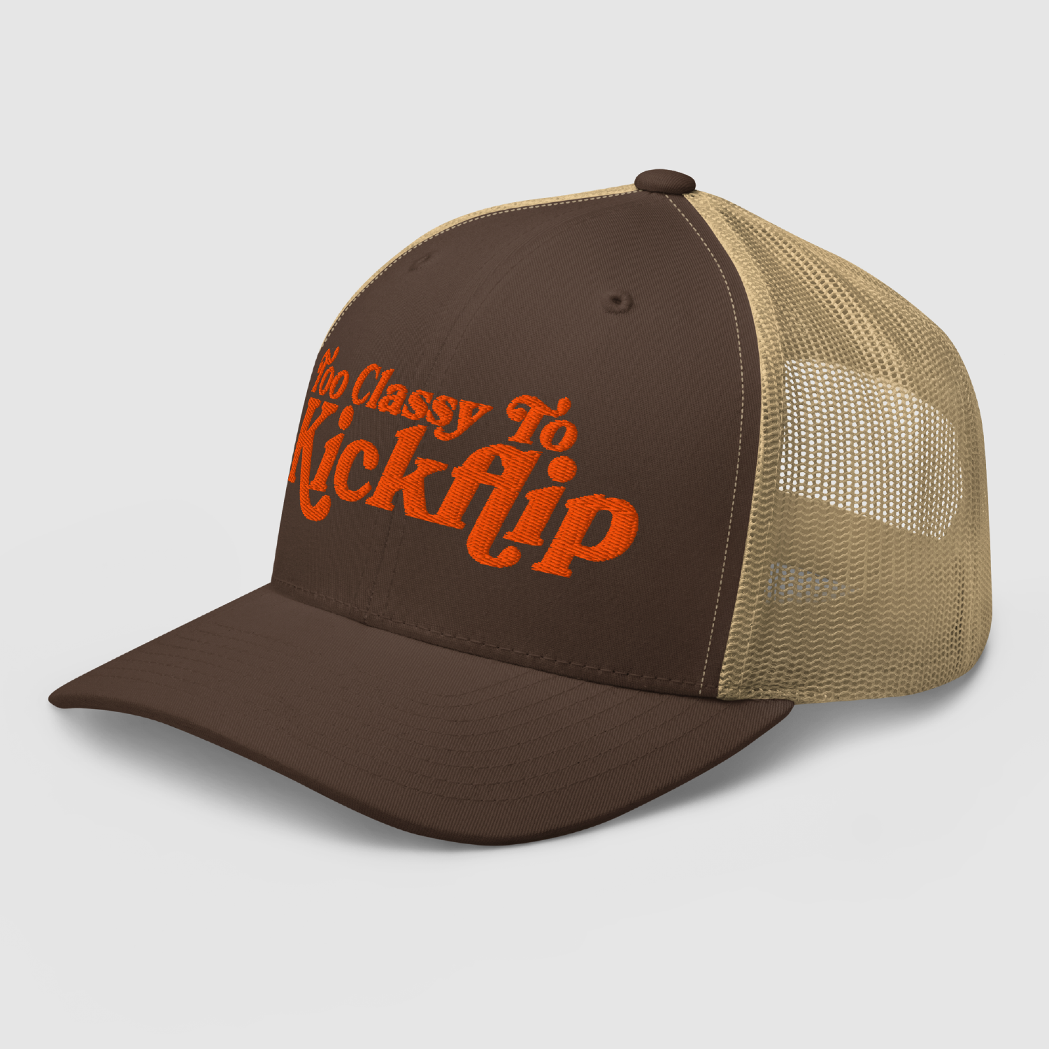 Angled shot showing bold orange embroidery on brown mesh cap