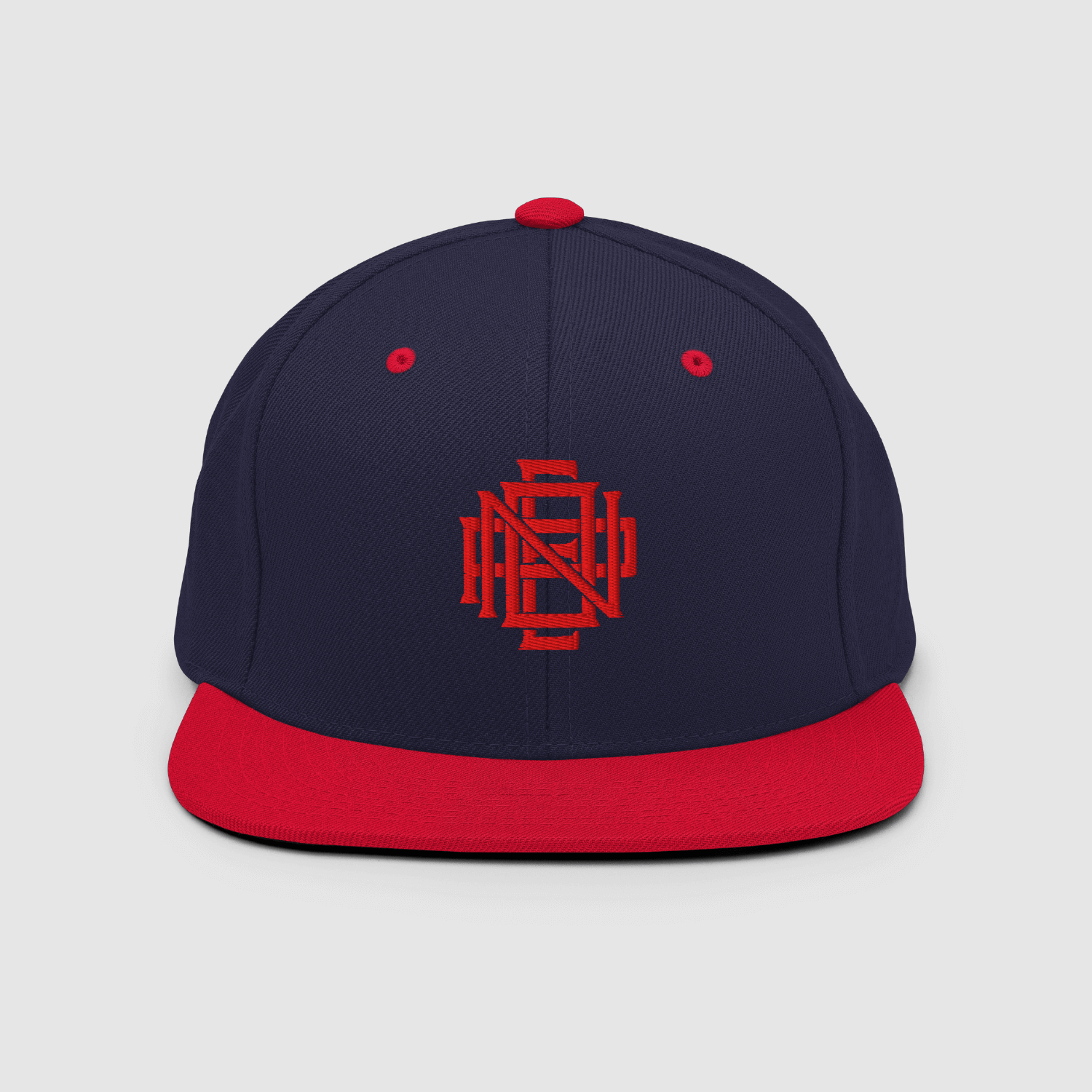 Front view of navy and red Nope Snapback cap with embroidered monogram