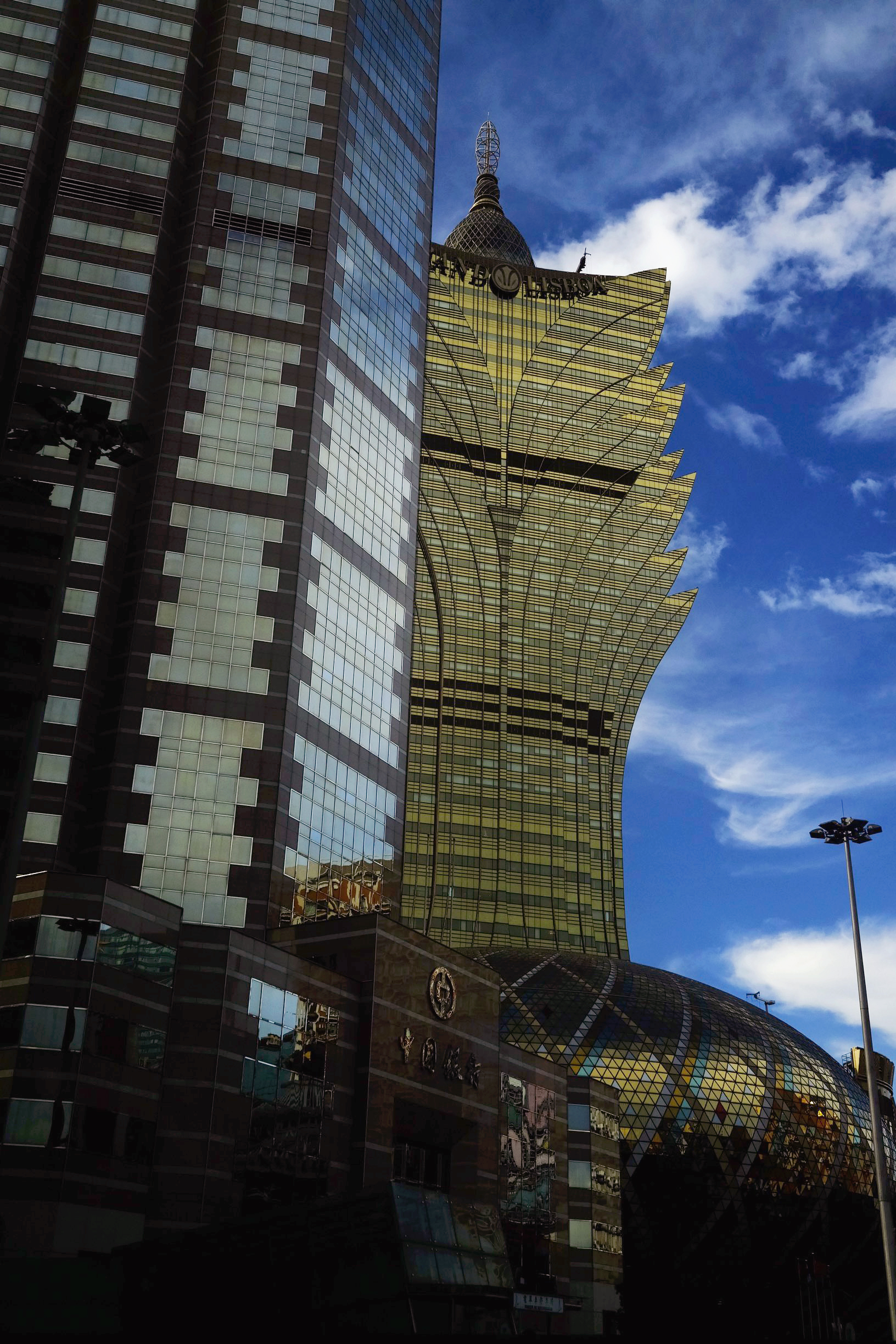  The Grand Lisboa hotel and casino peaks from behind the Bank of China building in Macau, China (Picture was taken from the backseat of a taxi) 