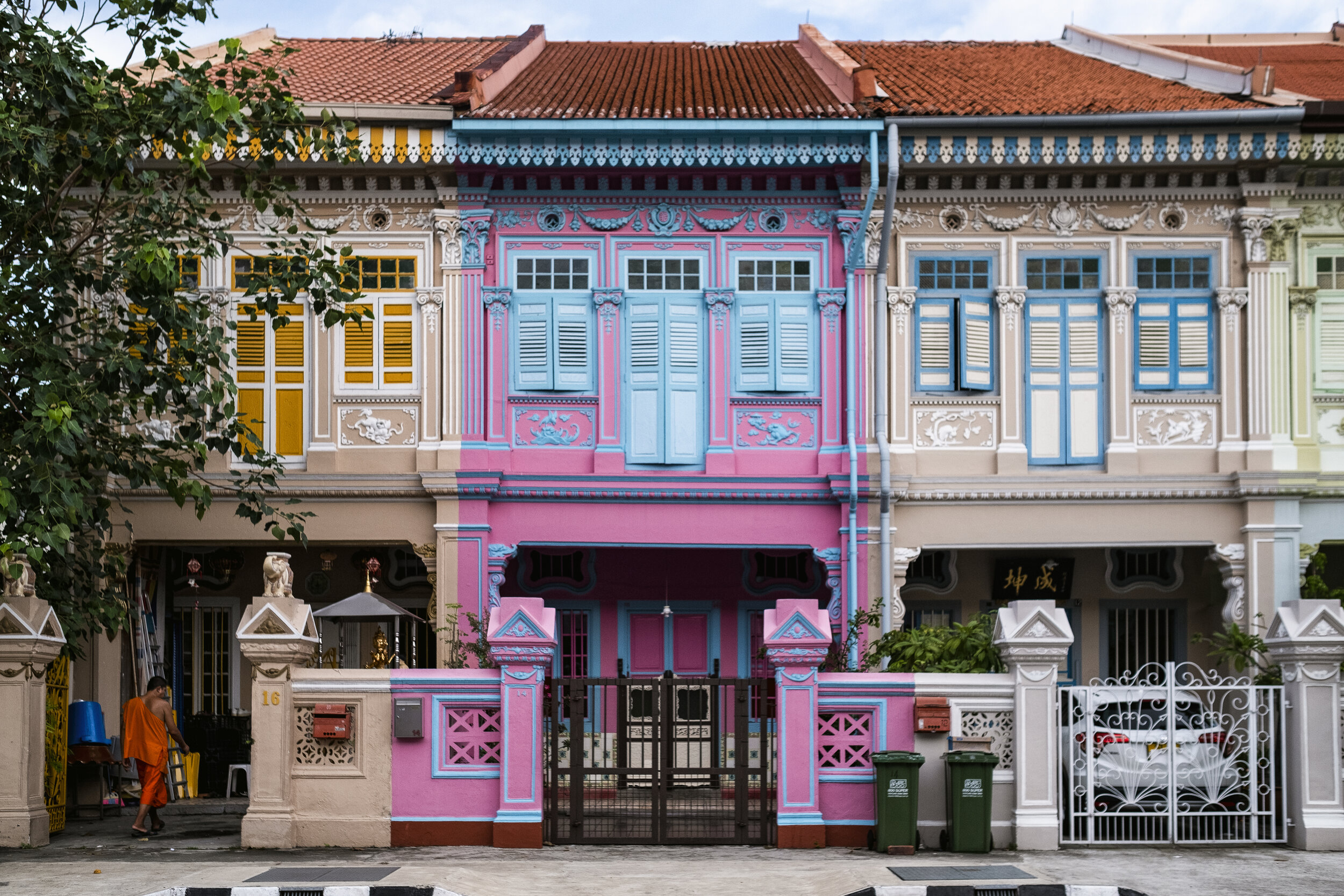  A buddhist monk walks into one of the multicoloured conservation Peranakan houses along a stretch of road in the heritage neighbourhood of Joo Chiat in eastern Singapore 