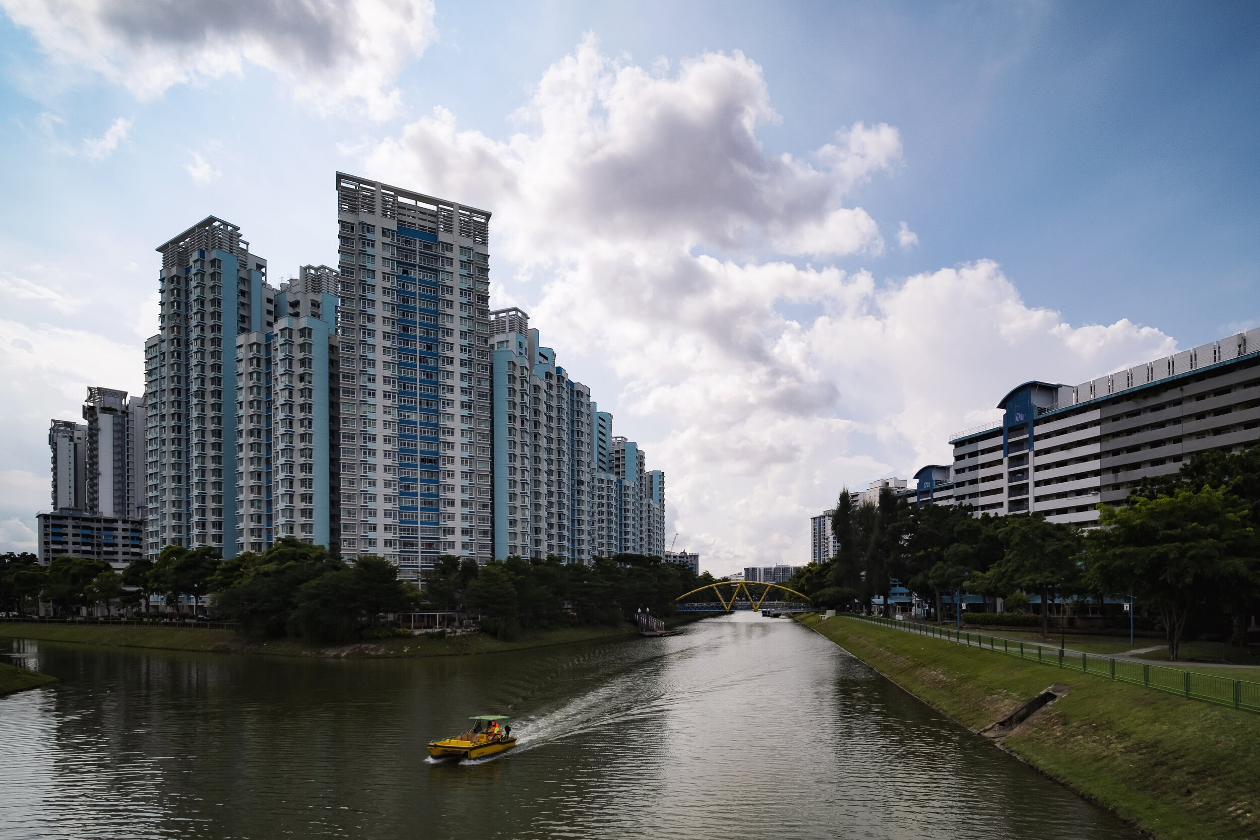  A trash collection boat travels down Kallang River past public housing flats in eastern Singapore 