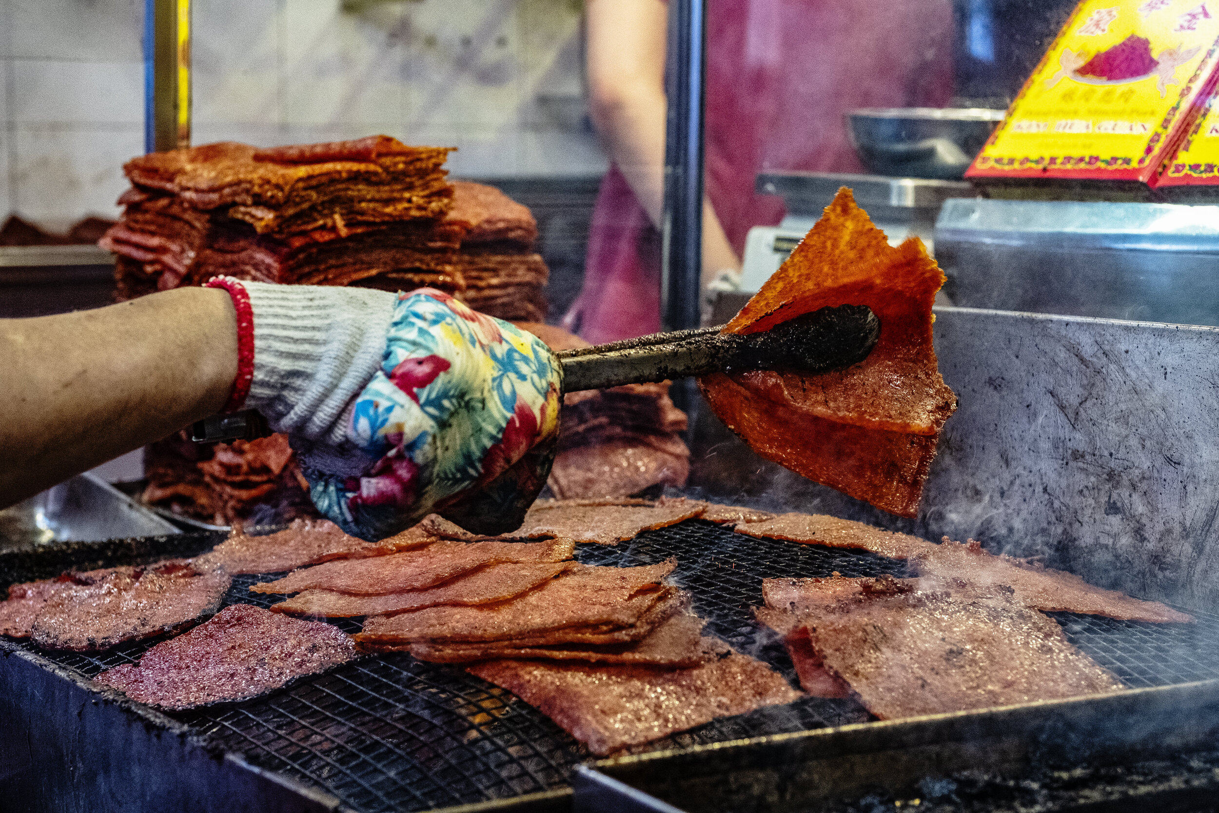  Pieces of marinated pork are grilled over charcoal as part of the final stages of Bak Kwa preparation 