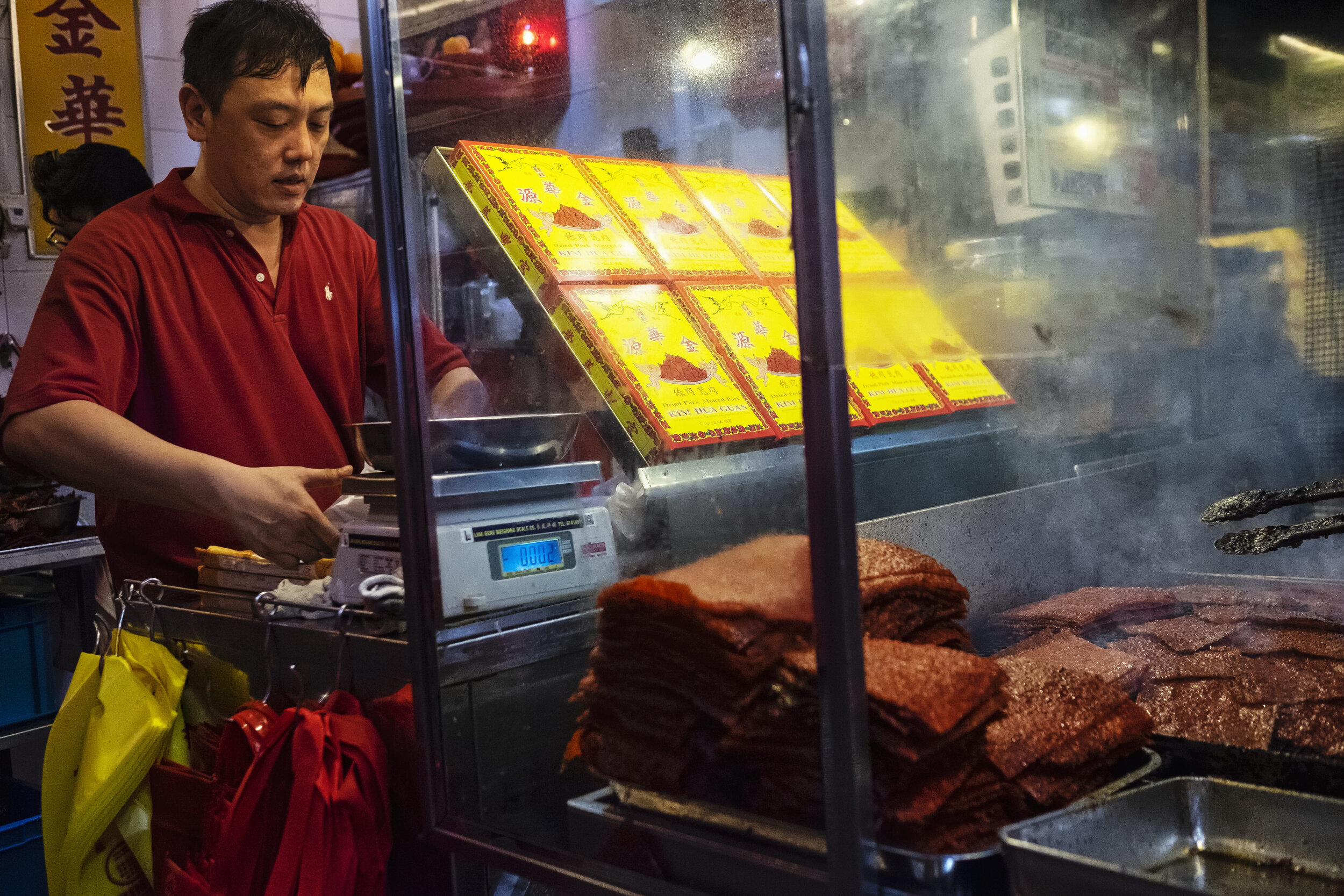  Second generation owner Ng Thian Beng, whose father founded Bak Kwa maker Kim Hua Guan in 1969, wraps a pack of Bak Kwa to fulfill a pre-order  