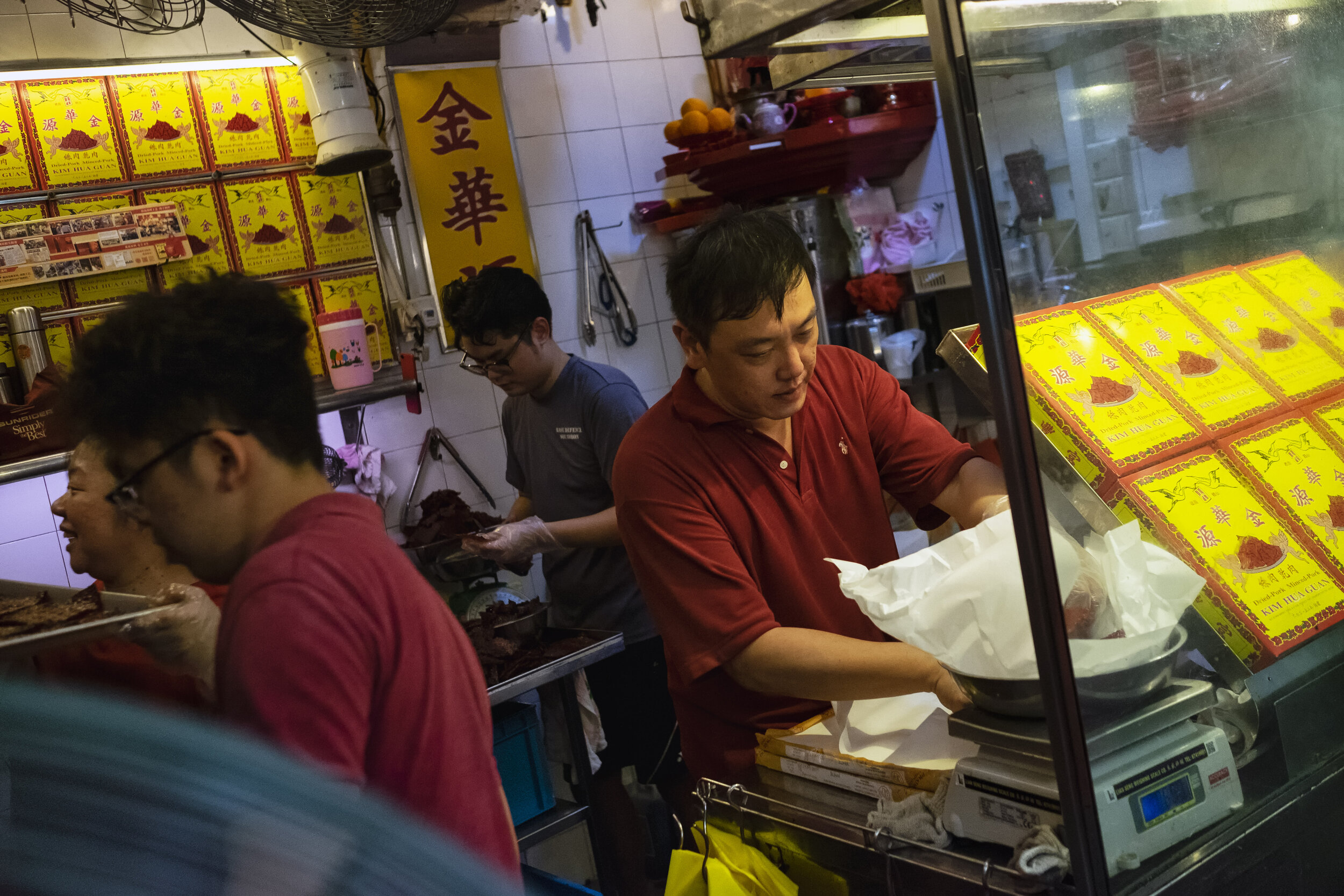 Second generation owner Ng Thian Beng, whose father founded Bak Kwa maker Kim Hua Guan in 1969, works alongside his staff to fulfill pre-orders in the confines of the stall  