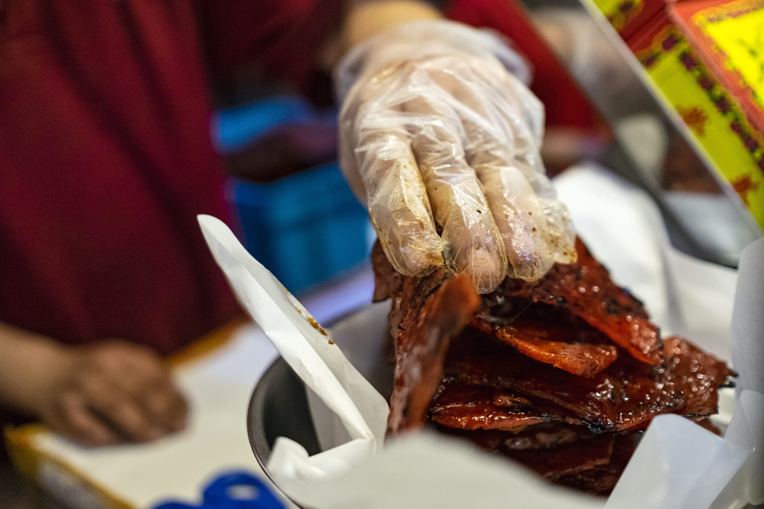  Second generation owner Ng Thian Beng, whose father founded Bak Kwa maker Kim Hua Guan in 1969, weighs a stack of Bak Kwa before packing them 