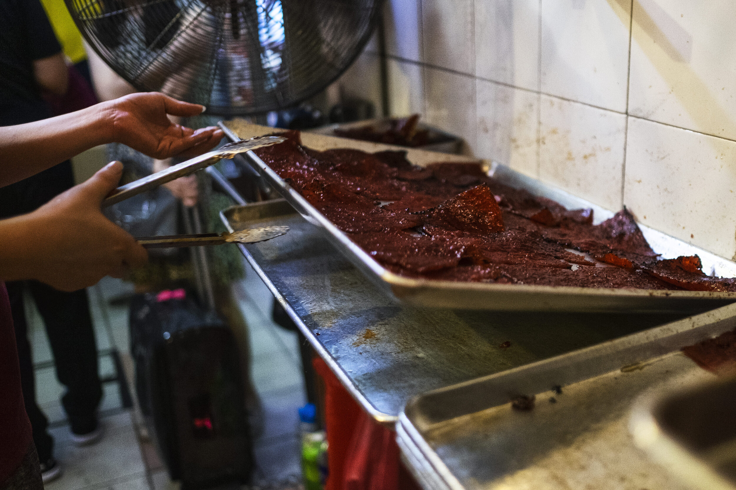  Another tray of freshly grilled Bak Kwa hits the rack to be air cooled before they get sorted for packing 