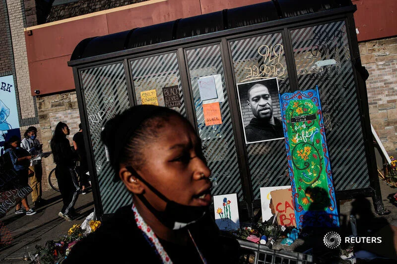  A picture of African-American man George Floyd is seen at a makeshift memorial put up by protesters at the corner where he got arrested, in the aftermath of a white police officer getting caught on a bystander's video pressing his knee into Floyd's 