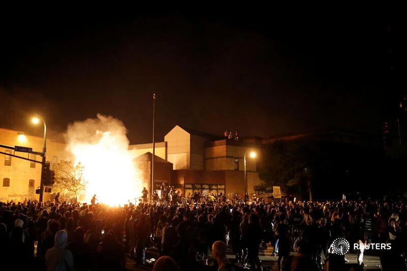  Protesters gather around after setting fire to the entrance of a police station as demonstrations continue after a white police officer was caught on a bystander's video pressing his knee into the neck of African-American man George Floyd, who later