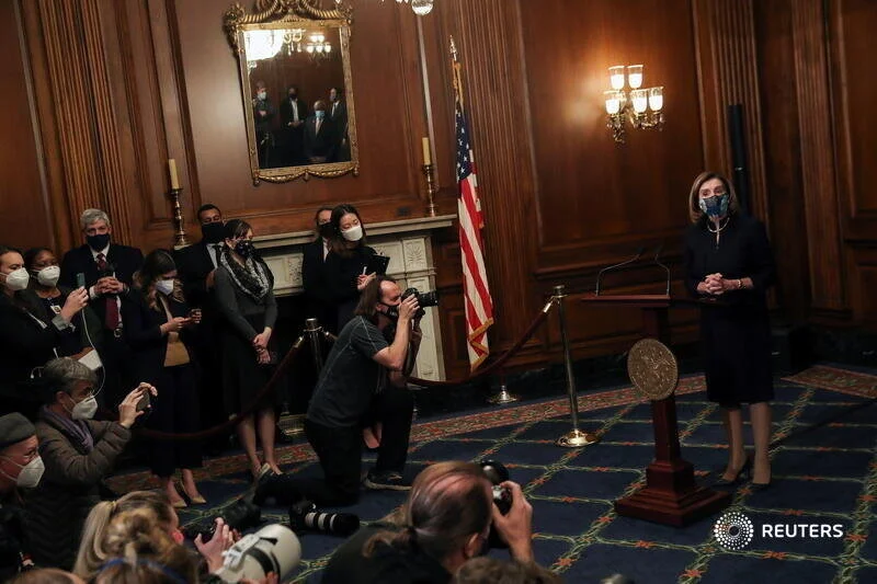  U.S. House Speaker Nancy Pelosi (D-CA) speaks to the media before signing the article of impeachment against U.S. President Donald Trump in an engrossment ceremony, at the U.S. Capitol in Washington January 13, 2021. REUTERS/Leah Millis 
