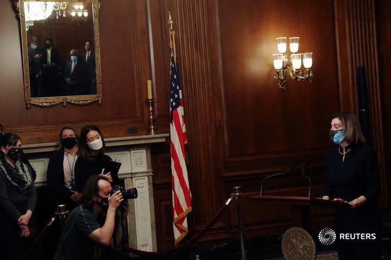  U.S. House Speaker Nancy Pelosi (D-CA) speaks to the media before signing the article of impeachment against U.S. President Donald Trump in an engrossment ceremony, at the U.S. Capitol in Washington January 13, 2021. REUTERS/Leah Millis 