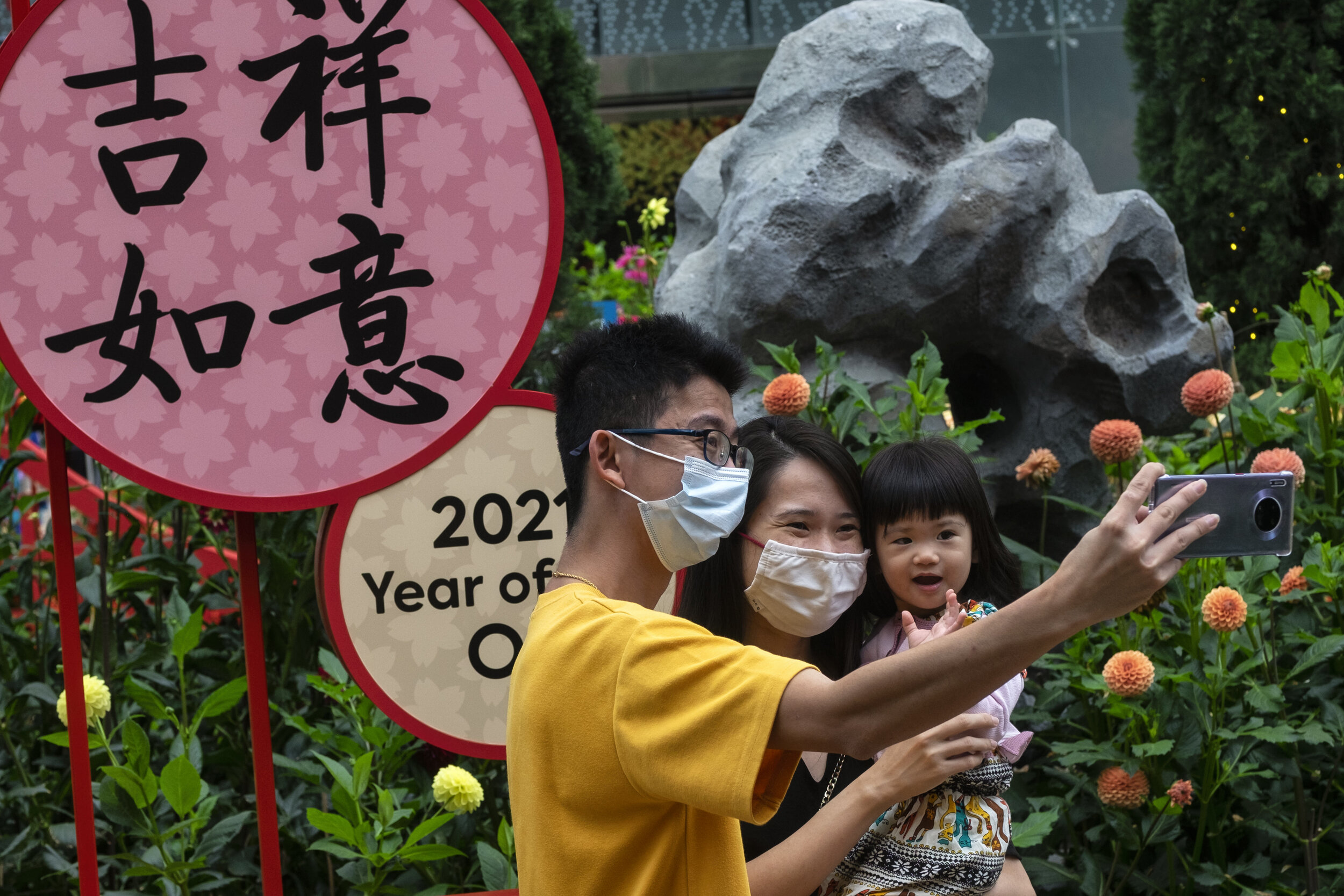  Visitors pose for a wefie during the annual Dahlia Dreams floral display ahead of the Chinese Lunar New Year of the Ox, otherwise known as the Spring Festival, at Singapore's Gardens by the Bay, January 31, 2021. REUTERS/Loriene Perera 