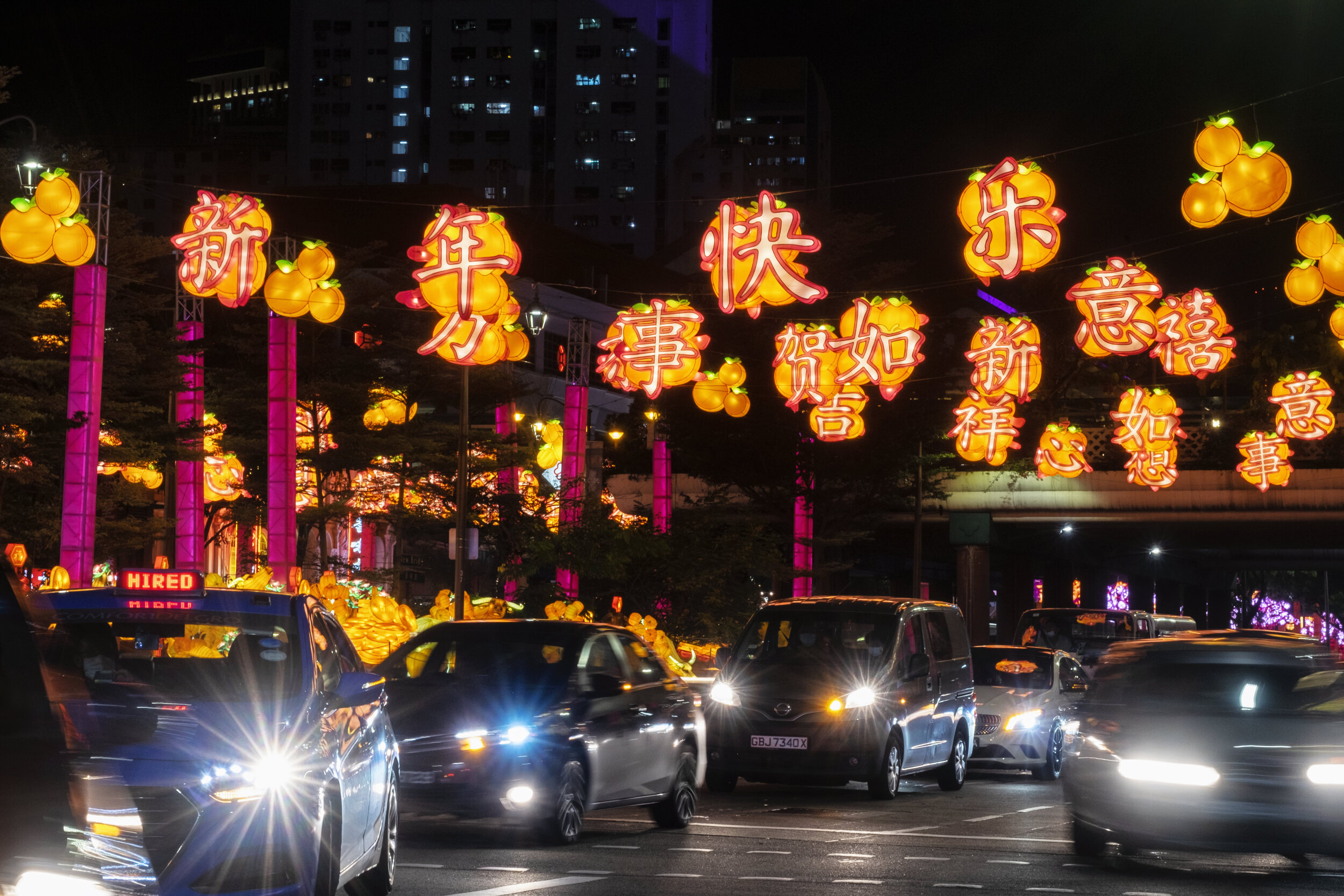  Lighting decorations of auspicious Chinese sayings hang above a road ahead of the Chinese Lunar New Year of the Ox, otherwise known as the Spring Festival, in Singapore's Chinatown, January 31, 2021. Picture taken with long exposure. REUTERS/Loriene