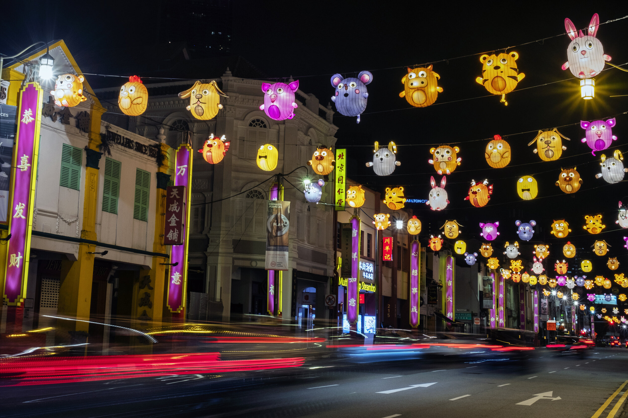  Lighting decorations in the shape of the Chinese zodiac animals hang above a road ahead of the Chinese Lunar New Year of the Ox, otherwise known as the Spring Festival, in Singapore's Chinatown, January 31, 2021. Picture taken with long exposure. RE