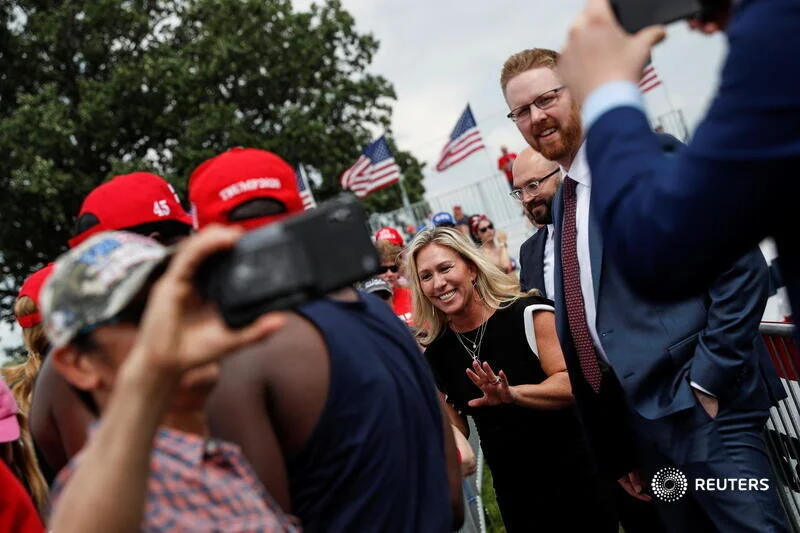  U.S. Rep. Marjorie Taylor Greene (R-GA) interacts with supporters of former U.S. President Donald Trump as they gather for his first post-presidency campaign rally at the Lorain County Fairgrounds in Wellington, Ohio, U.S., June 26, 2021. REUTERS/Sh
