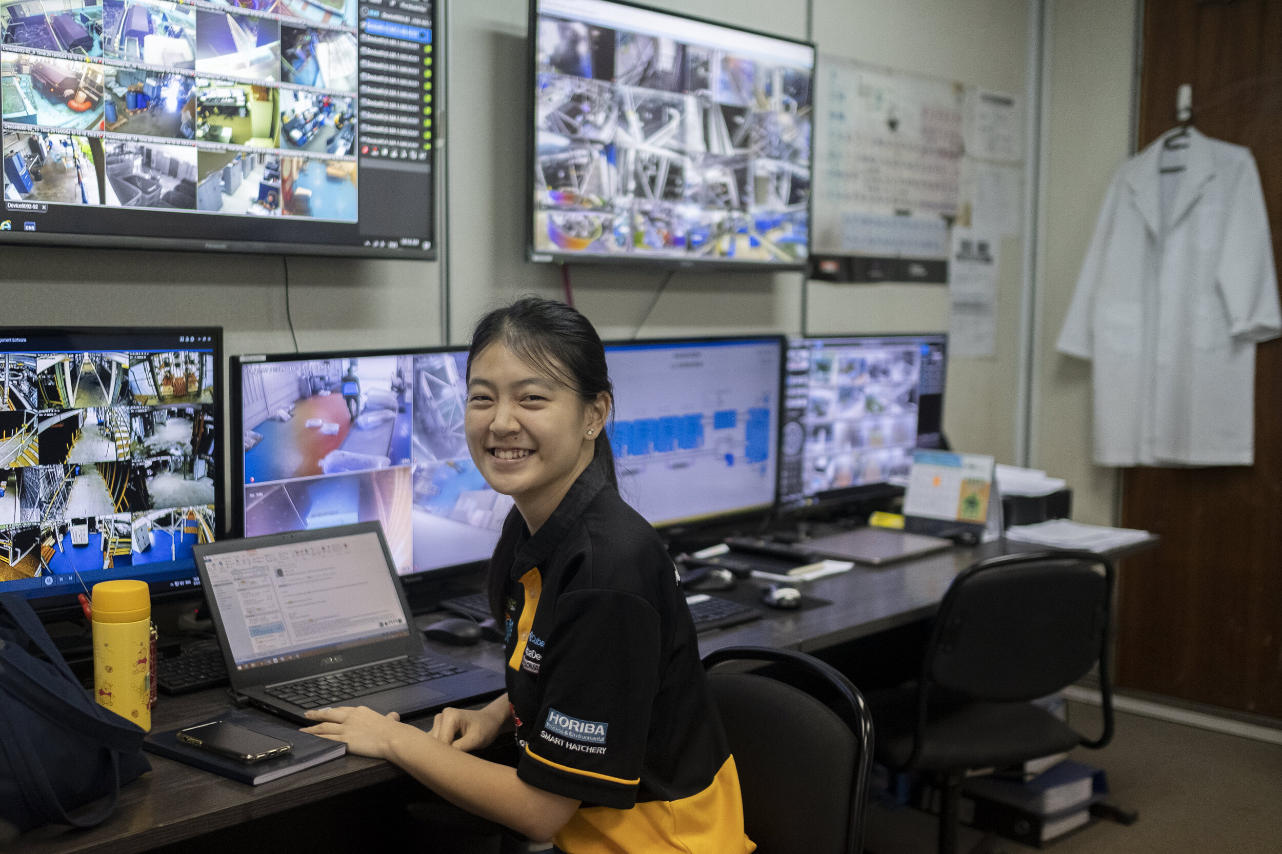  An employee smiles while watching surveillance monitors at Apollo Aquaculture Group’s three-tiered vertical fish farm in northern Singapore 