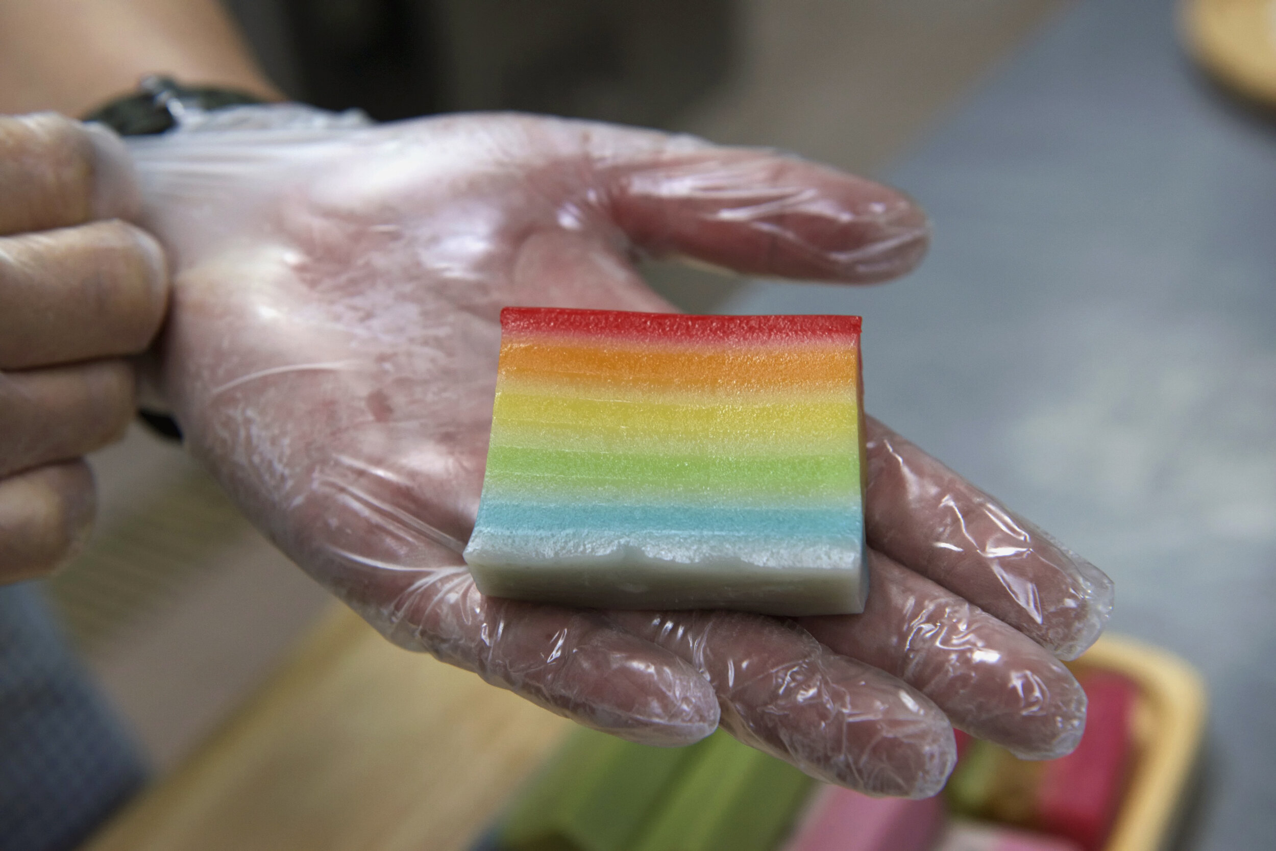  Alan Tan, third-generation co-owner of traditional Peranakan confectionery HarriAnns, holds a piece of rainbow lapis at their central kitchen in Singapore April 20, 2018. 