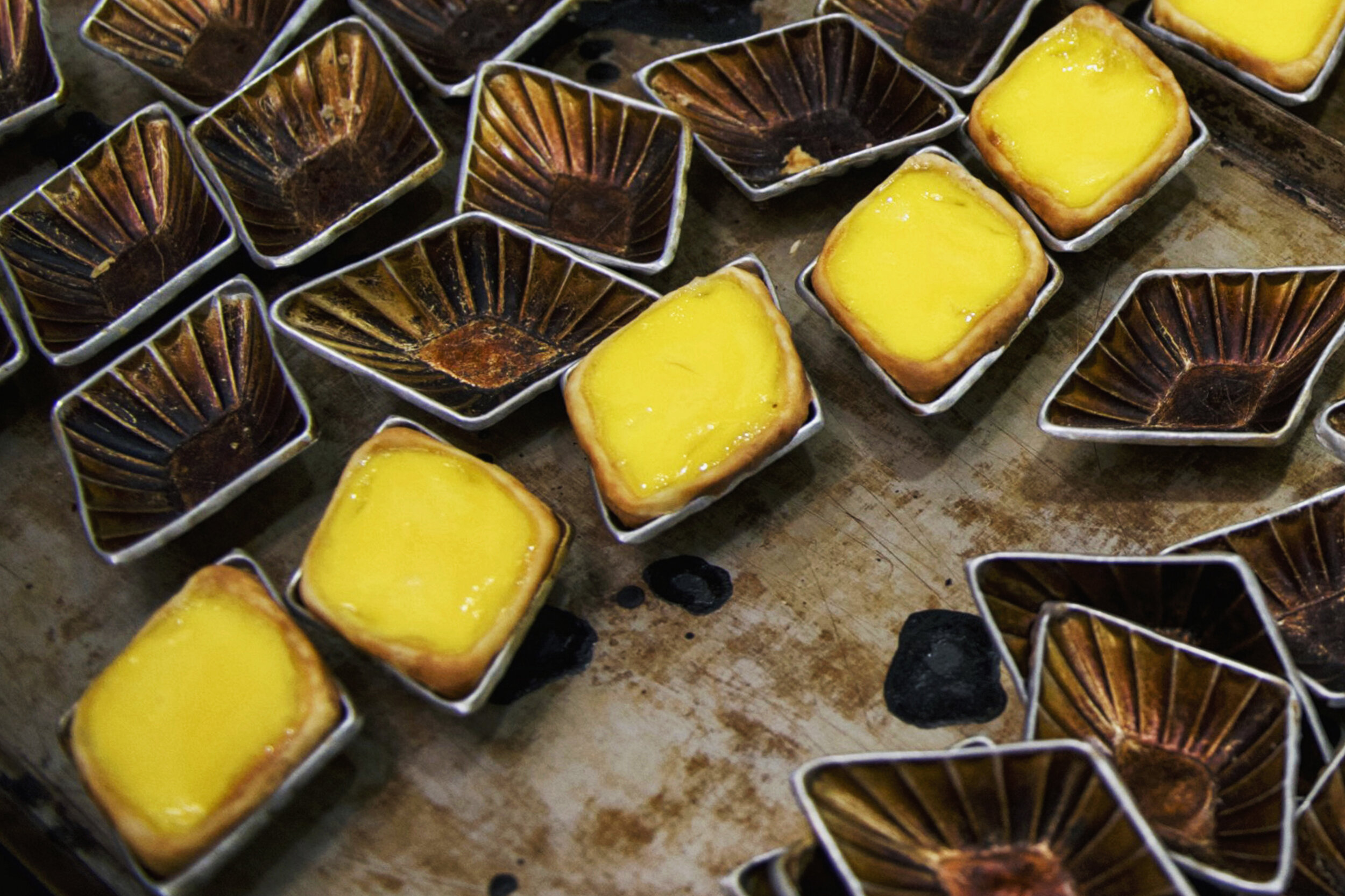  Freshly baked egg tarts cool off on a tray before they are shucked from their molds at the traditional Cantonese confectionery Tong Heng in Singapore April 21, 2018. 