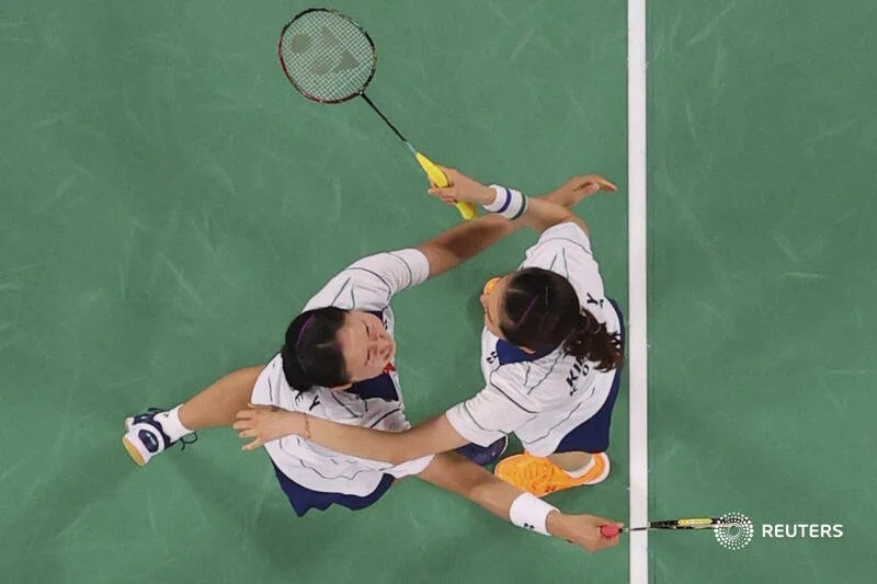  Tokyo 2020 Olympics - Badminton - Women's Doubles - Bronze medal match - MFS - Musashino Forest Sport Plaza, Tokyo, Japan – August 2, 2021.  Kim So-Yeong of South Korea and Kong Hee-Yong of South Korea reach out to hug after winning the match agains
