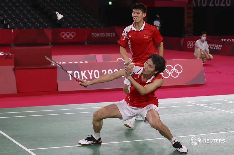  Tokyo 2020 Olympics - Badminton - Men's Doubles - Gold medal match - MFS - Musashino Forest Sport Plaza, Tokyo, Japan – July 31, 2021.  Li Junhui of China in action next to Liu Yuchen of China during the match against Lee Yang of Taiwan and Wang Chi