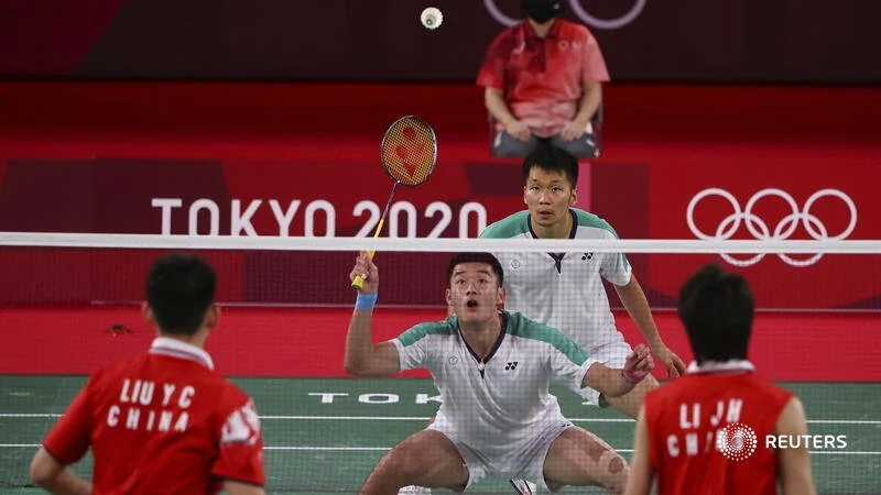  Tokyo 2020 Olympics - Badminton - Men's Doubles - Gold medal match - MFS - Musashino Forest Sport Plaza, Tokyo, Japan – July 31, 2021.  Wang Chi-Lin of Taiwan in action next to Lee Yang of Taiwan during the match against Li Junhui of China and Liu Y
