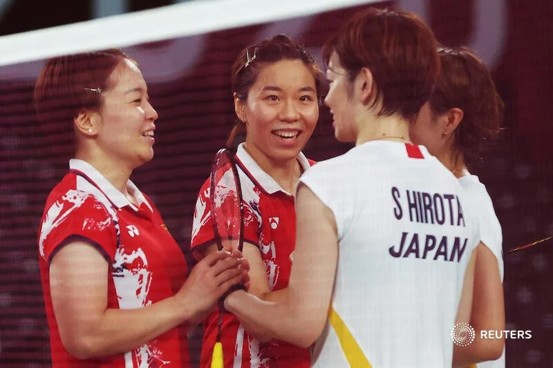  Tokyo 2020 Olympics - Badminton - Women's Doubles - Quarterfinal - MFS - Musashino Forest Sport Plaza, Tokyo, Japan – July 29, 2021. Chen Qingchen of China and Jia Yifan of China speak with Yuki Fukushima of Japan and Sayaka Hirota of Japan after Ch