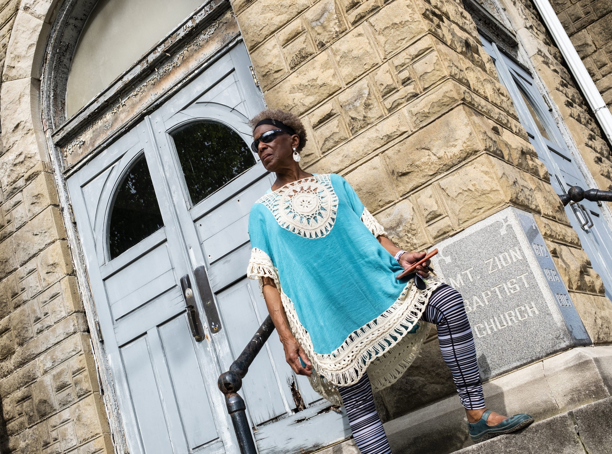  Mount Zion Baptist Church Preservation Society board member Dr. Tee Ford-Ahmed looks on while explaining the history and significance of the church next to its cornerstone in Athens, Ohio Thursday April 20, 2023. According to Mount Zion Baptist Chur