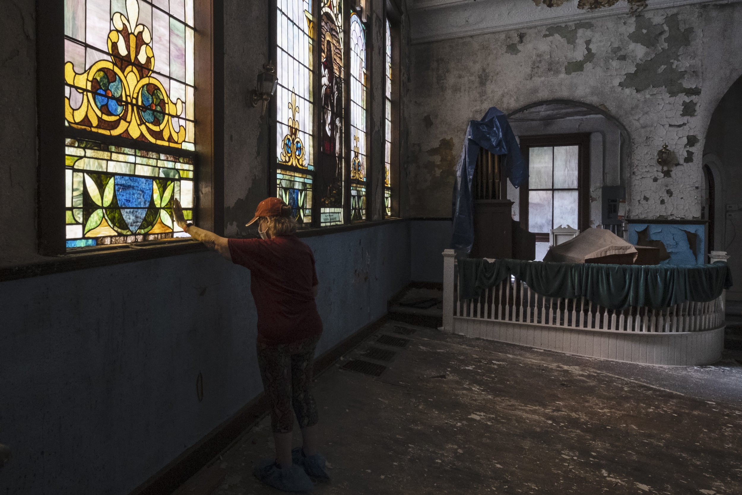  Retired school psychologist and Mount Zion Baptist Church Preservation Society's secretary Beth Amoriya touches the stained glass windows inside the church in Athens, Ohio Thursday April 20, 2023. According to Mount Zion Baptist Church Preservation 