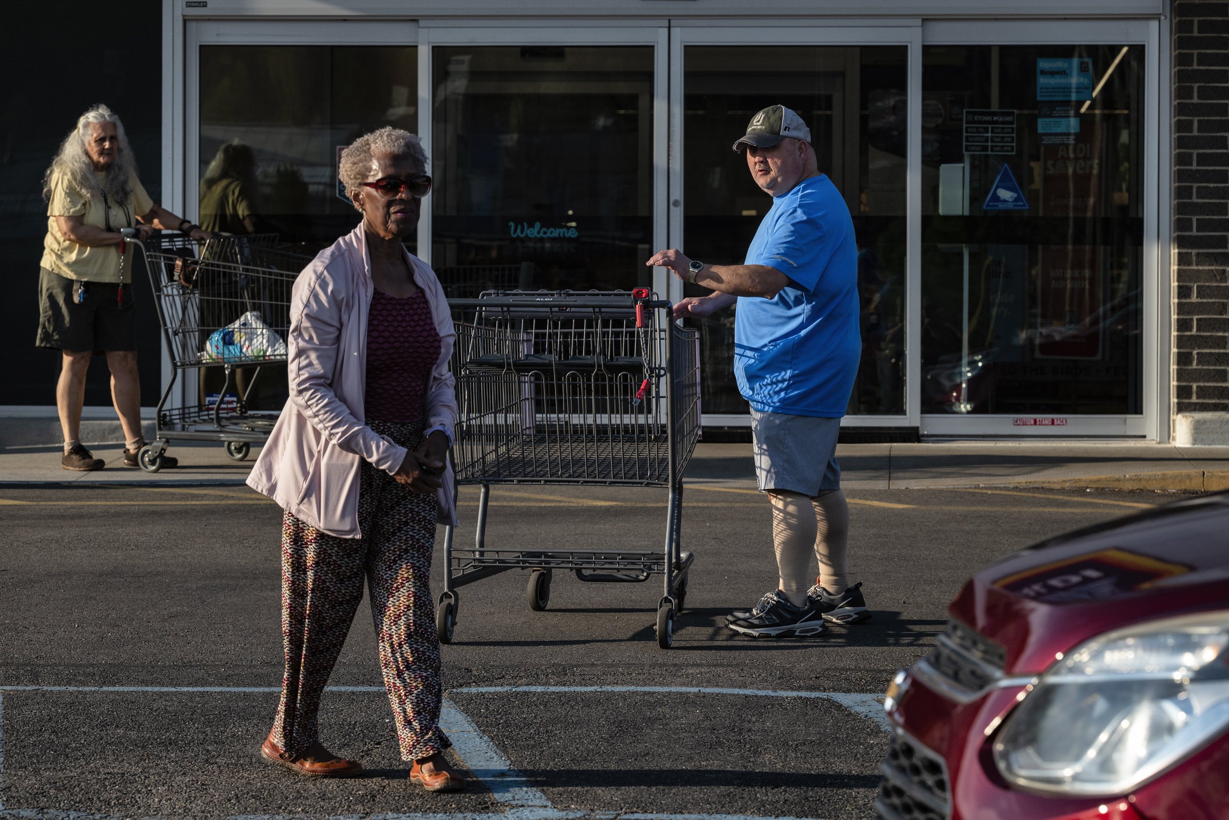  Dr. Tee Ford-Ahmed walks towards her car after passing her empty shopping cart to another shopper outside Aldi supermarket in Athens, Ohio, Saturday April 15, 2023.  