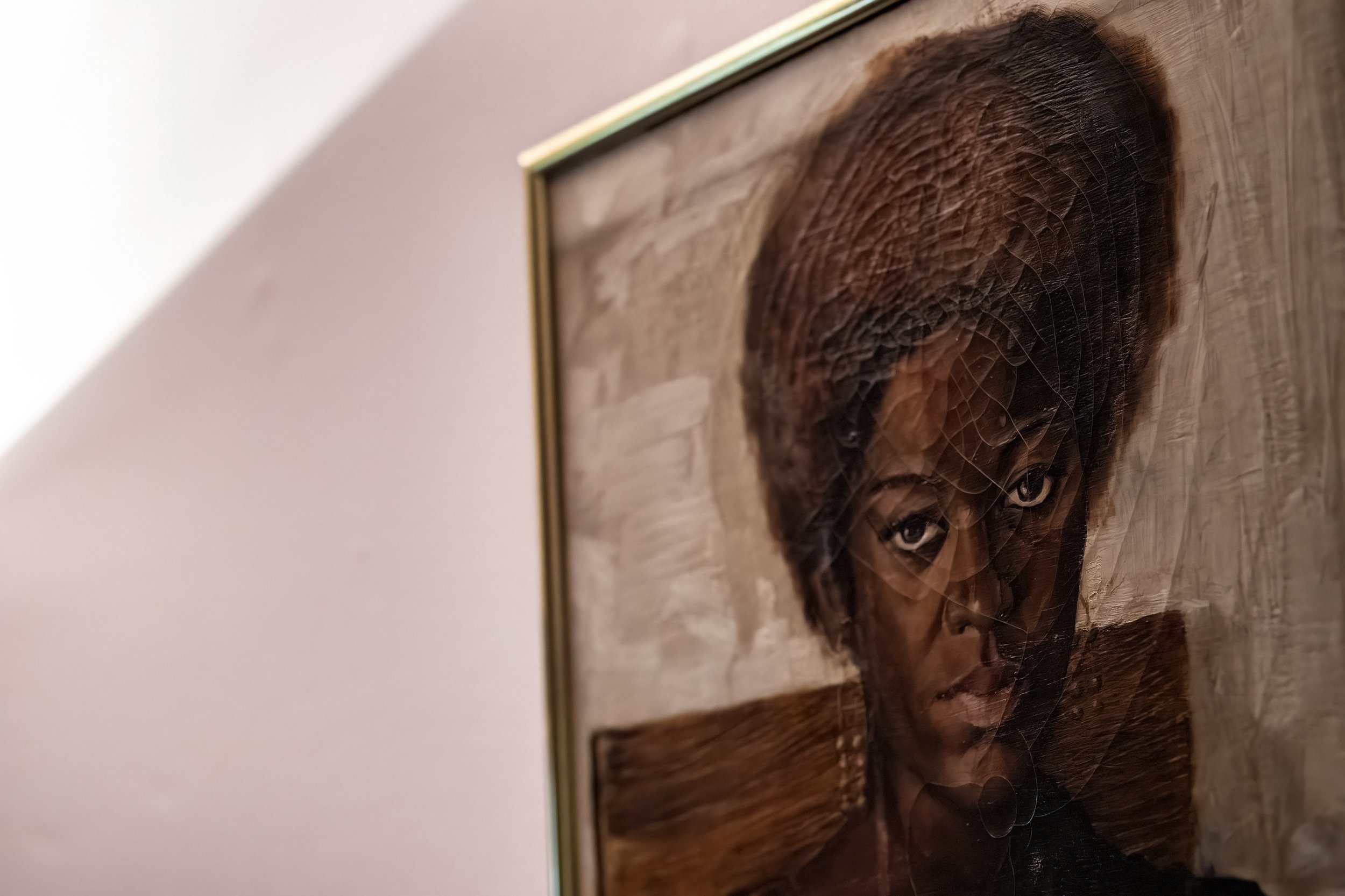  A close-up view of "Time", a painting by artist Charles Bible that composes of the physical features of Dr. Tee Ford-Ahmed and her sisters, hangs in her dining room at her home in Athens, Ohio, Friday March 31, 2023. Ford-Ahmed used to shop occasion