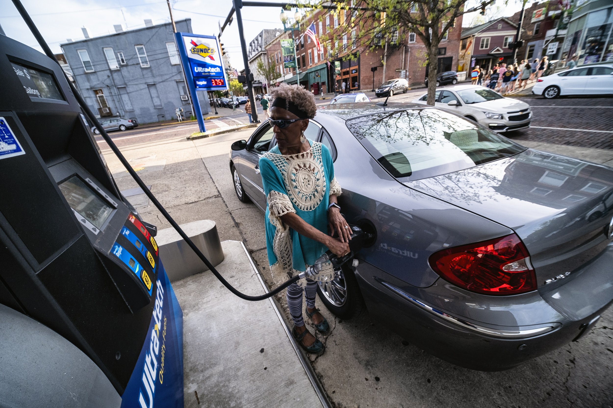  Dr. Tee Ford-Ahmed refuels her car at a Sunoco gas station in uptown Athens, Ohio Thursday April 20, 2023.  