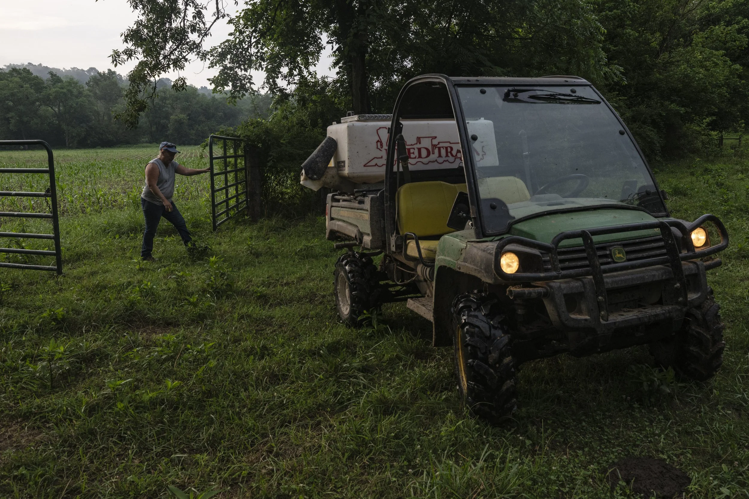  Pat Strode, a farmhand and the wife of manager Dan Strode of Goshen Run Farms, opens a gate to a pasture before feeding cows on the farm between Chesterhill and Stockport, Ohio, on Tuesday, July 8, 2025. Strode said she previously worked at the loca