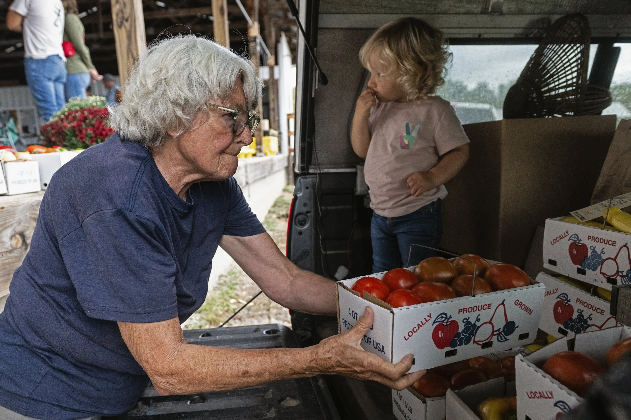  Co-founder Kathy Strode loads fresh produce into her truck bed as her grandson, Henry Schulz, looks on at the end of a produce auction at the Chesterhill Produce Auction in Chesterhill, Ohio, on Thursday, Sept. 24, 2025. Strode said she has been buy