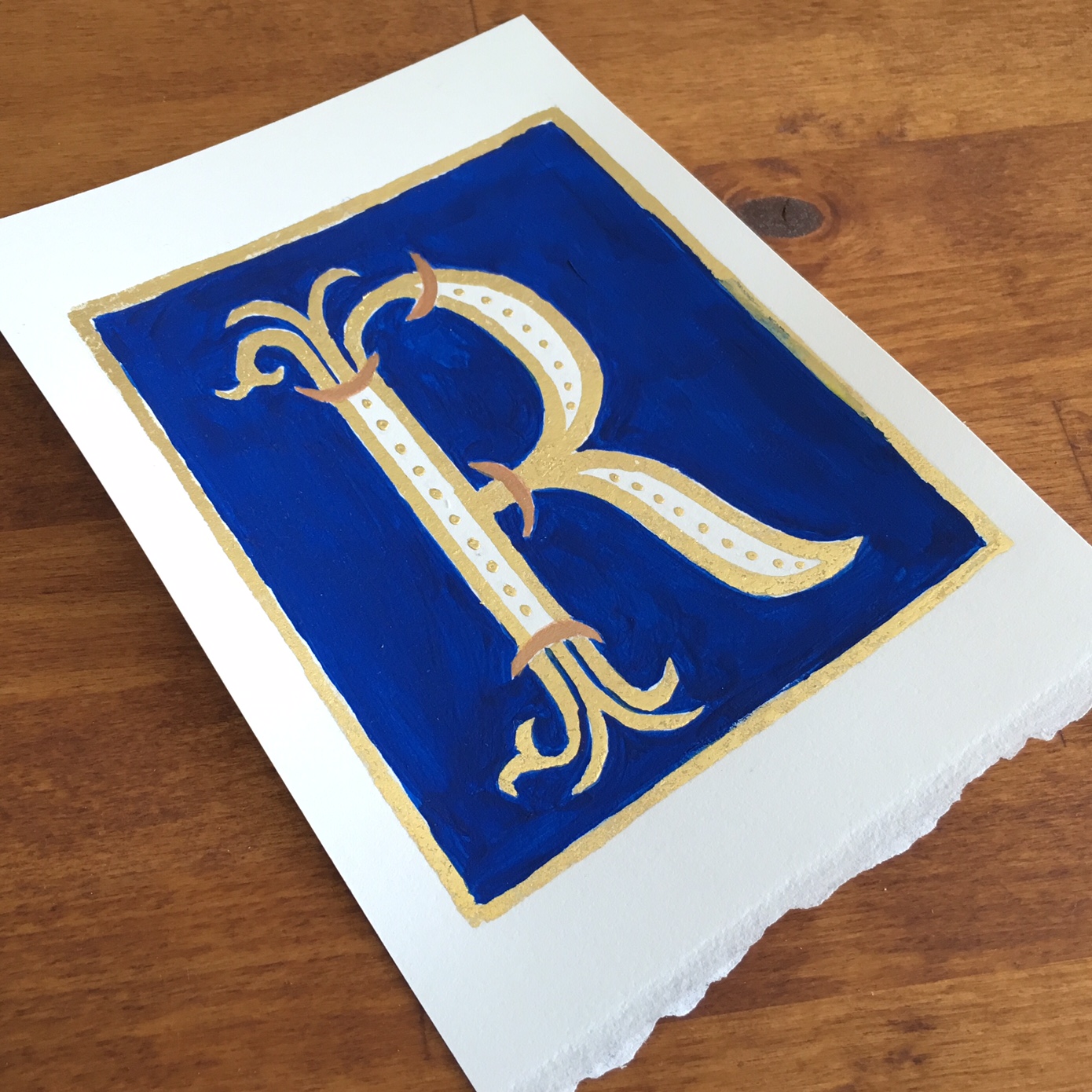  Decorated letter :: Gold "R" on blue background &nbsp;with gold border :: Opaline Lettering 