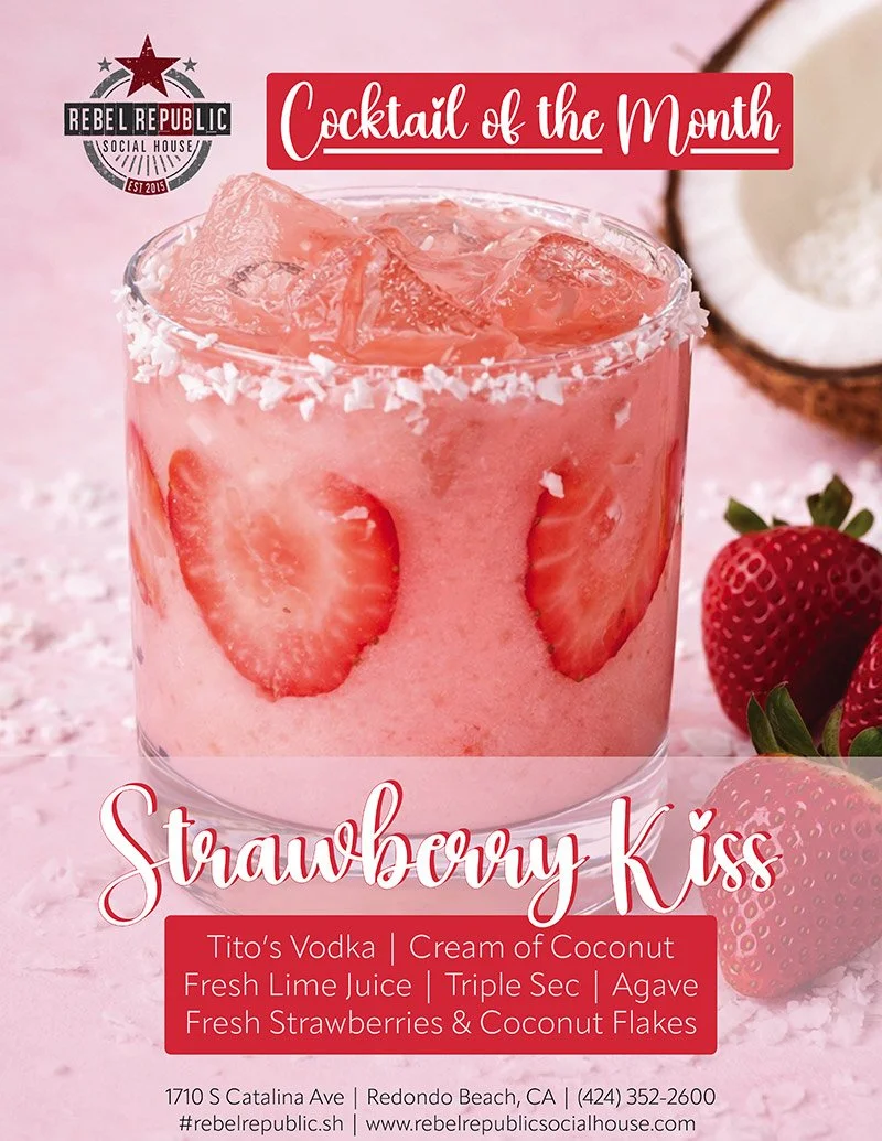 Strawberry cocktail with fresh strawberry slices and coconut flakes, styled on a pink surface with whole strawberries.