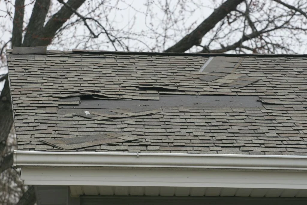 Pictured here is a home in Carol Stream, IL that had its shingles torn from the roof due to excessive winds.