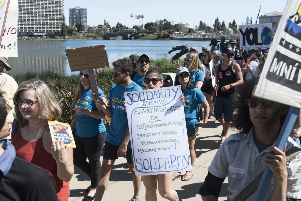 A young woman marches with other demonstrators at the People's Climate March in Oakland, CA on April 29, 2017, the 100th day of Trump's presidency. Thousands gathered to stand up for the protection of our environment, our health, and worker's rights. During his campaign and his presidency, Trump has called climate change a hoax, has pulled back restrictions for greenhouse gas emissions at power plants, and even signed an executive order that would expand oil drilling in the Arctic and Atlantic oceans. 