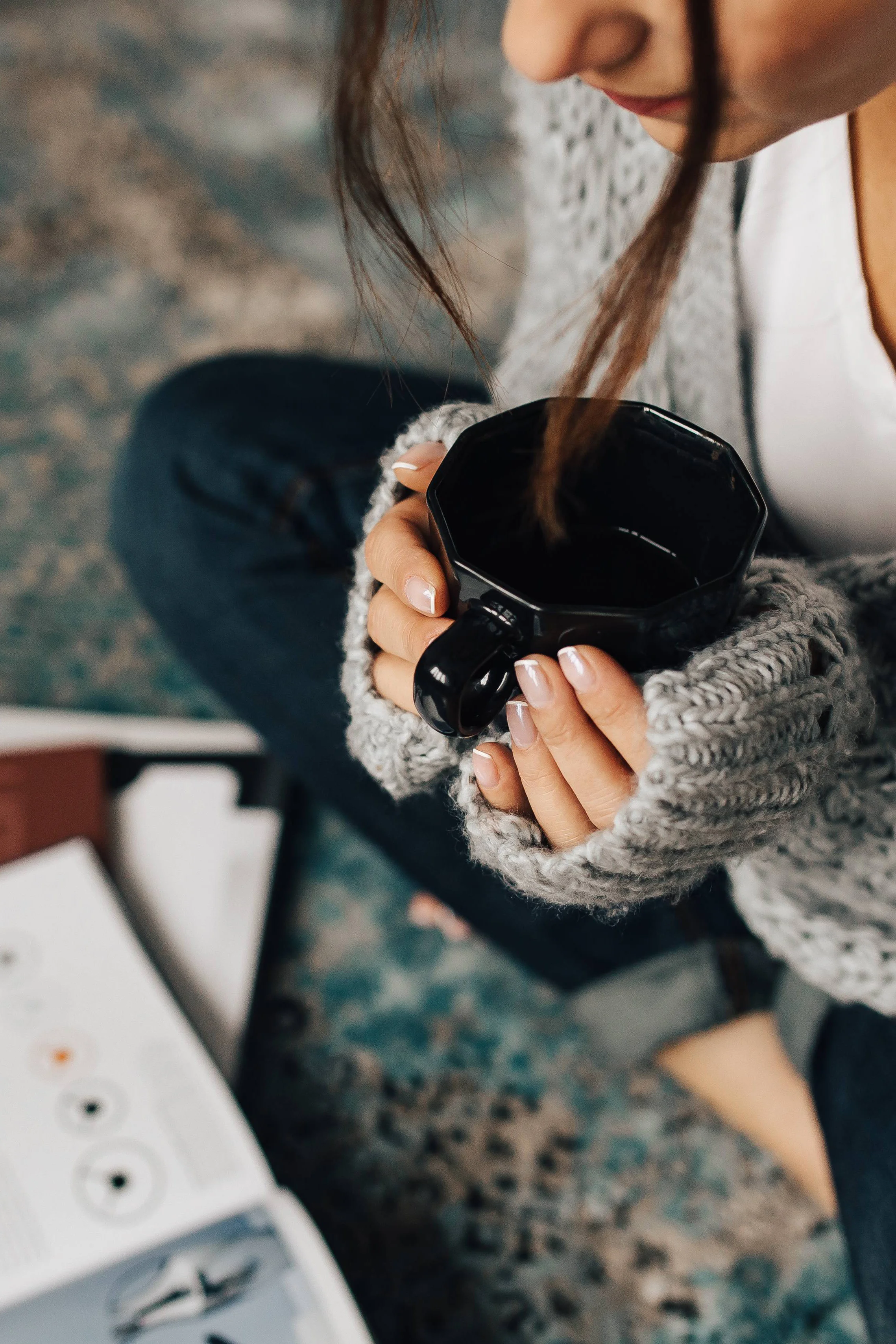 kaboompics_Woman reading magazines on the floor while enjoying her cup of tea.jpg