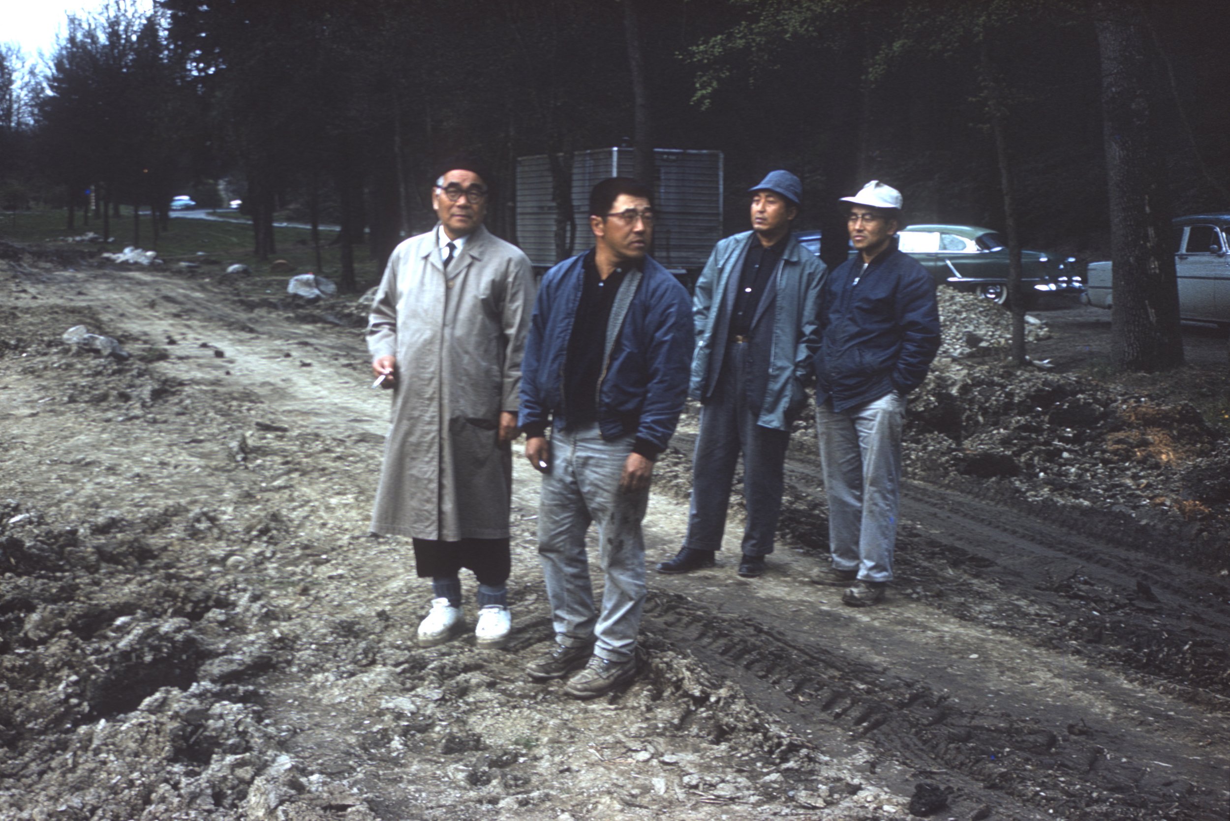 A rare color photograph of Juki Iida (left) with Kaz (Kei) Ishimitsu, Richard (Dick) Yamasaki, and William (Bill) Yorozu, taken during the construction of the Seattle Japanese Garden from 1959 to 1960 (photo undated).