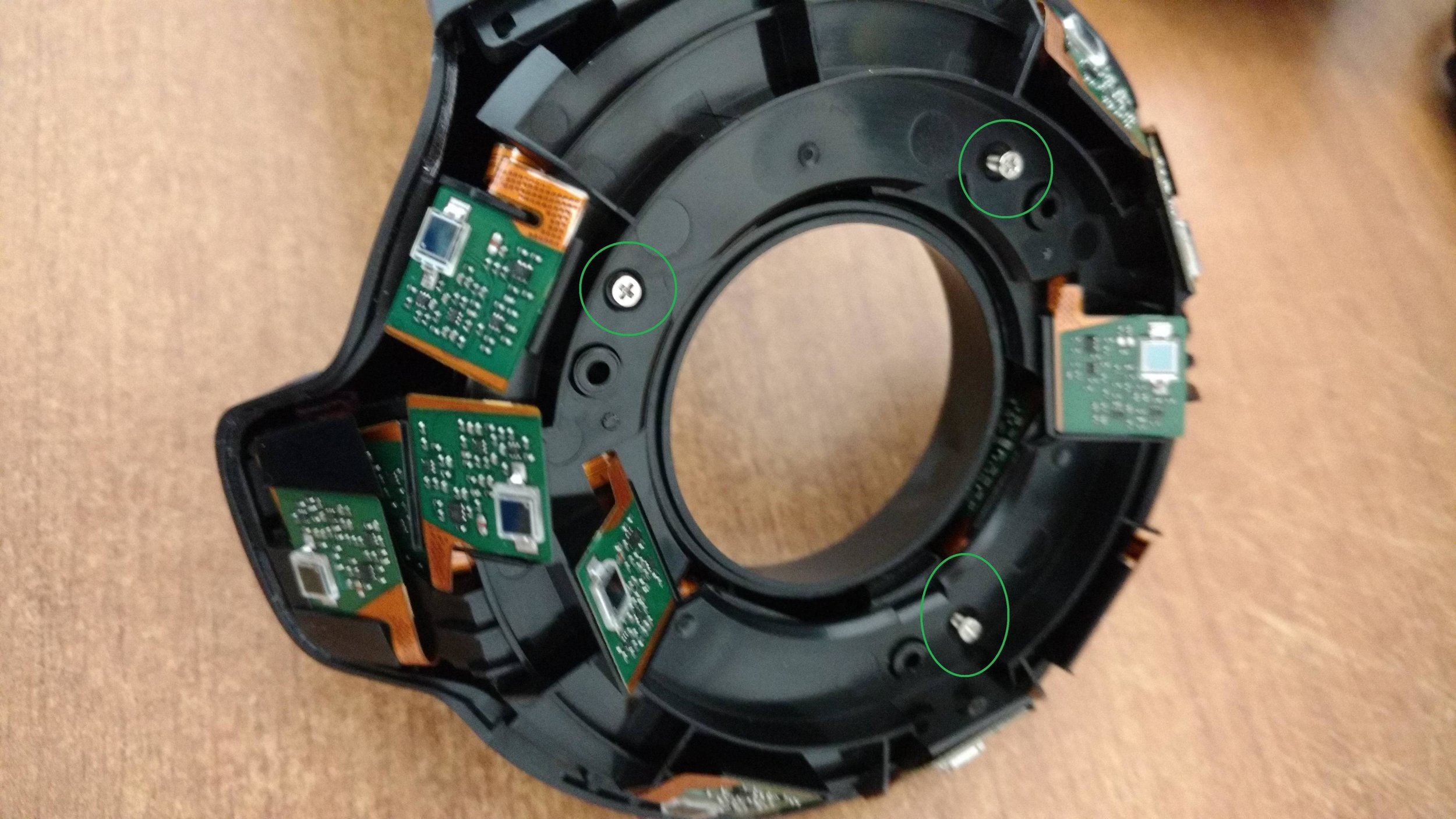3. Remove the top side of the sensor ring. It has a bit of adhesive and you may feel squimish doing this. Just make sure you are applying gradual strength because you do want to approach this as delicately as possible. Once removed you'll see 3 silver screws which you can remove with your size 0 Phillips which will allow you to remove the bottom sensor ring cover.